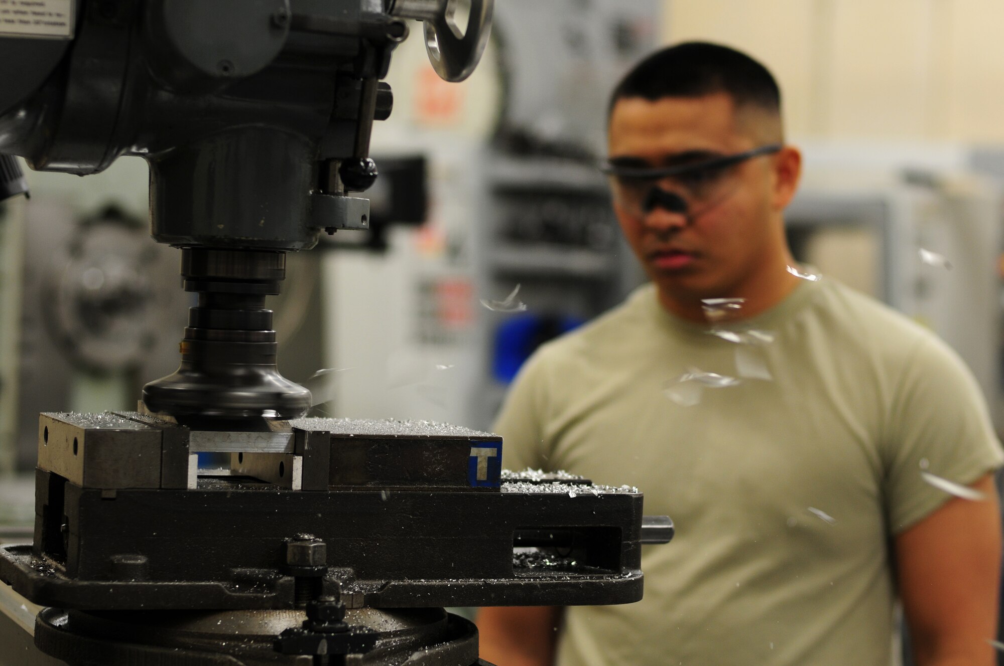 ROYAL AIR FORCE LAKENHEATH, England – Senior Airman Wendel Garcia, 48th Equipment Maintenance Squadron metals technology journeyman, watches as a manual milling machine shaves down metal equipment Nov. 20, 2012. The 48th EMS metals technology shop’s mission is to function as the U.S. Air Force’s welders by fabricating or repairing aircraft and ground equipment components. (U.S. Air Force photo by Airman 1st Class Cory D. Payne)