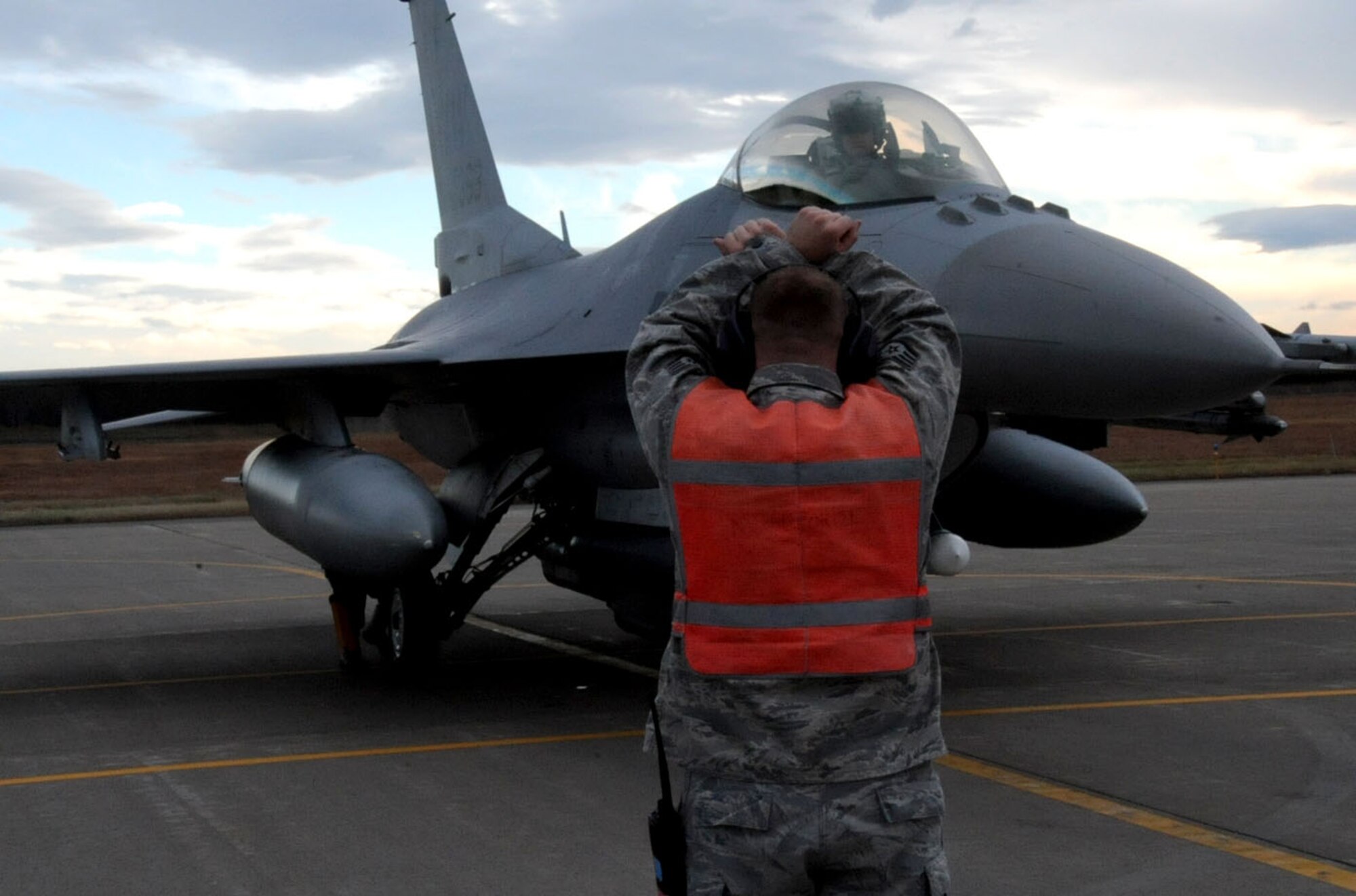 A crew chief signals a pilot to hold the brakes as the ground crew removes the aircraft chocks prior to taxi during Keen Sword 2013 at Misawa Air Base, Japan, Nov. 8, 2012. For the exercise, units from the United States Army, Navy, Air Force and Marine Corps are conducting training with their Japan-Self Defense Force counterparts at military installations throughout mainland Japan, Okinawa and in the waters surrounding Japan. (U.S. Air Force photo by Airman 1st Class Kenna Jackson)