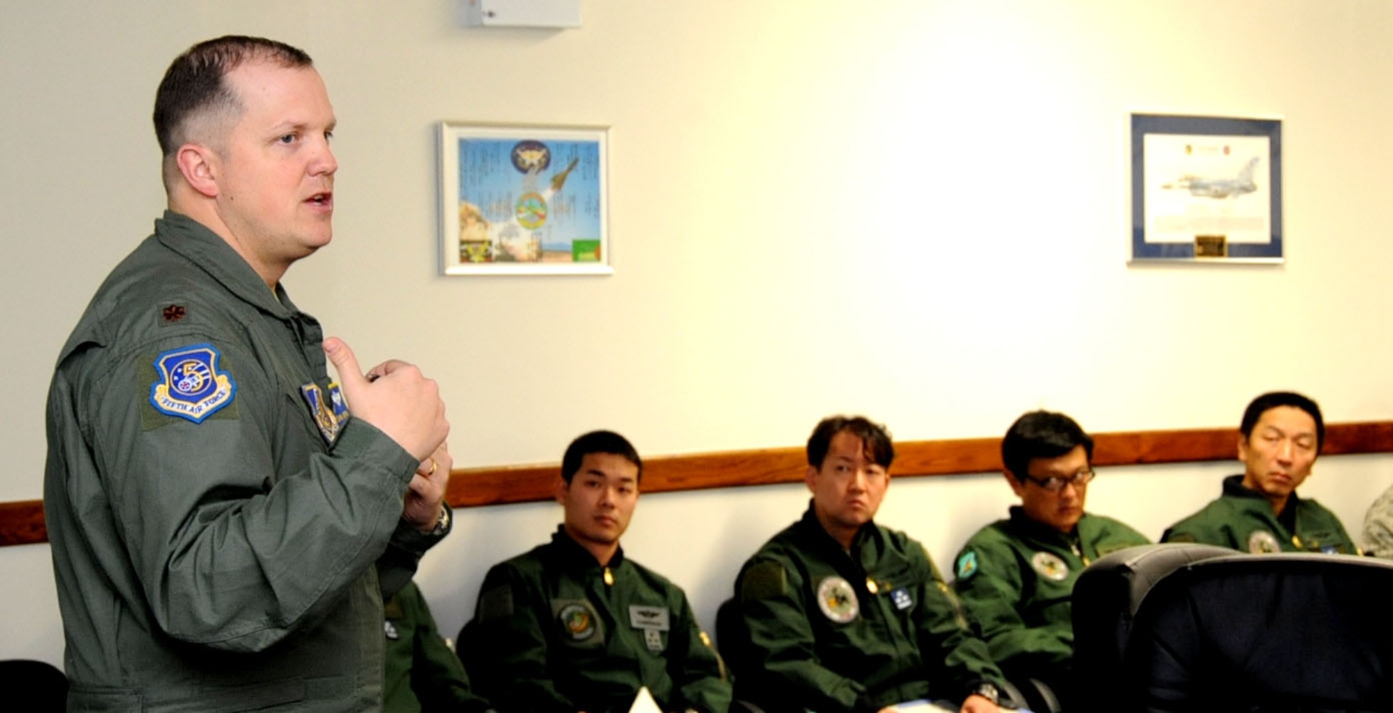 U.S. Air Force Maj. John Greven, 5th Air Force exercise control group lead, briefs American and Japanese pilots during Keen Sword 2013 at Misawa Air Base, Japan, Nov. 7, 2012. During the briefing, Greven informed the pilots on expected weather conditions and their temporary chain of command to be used throughout the 12-day exercise. (U.S. Air Force photo by Airman 1st Class Kenna Jackson)