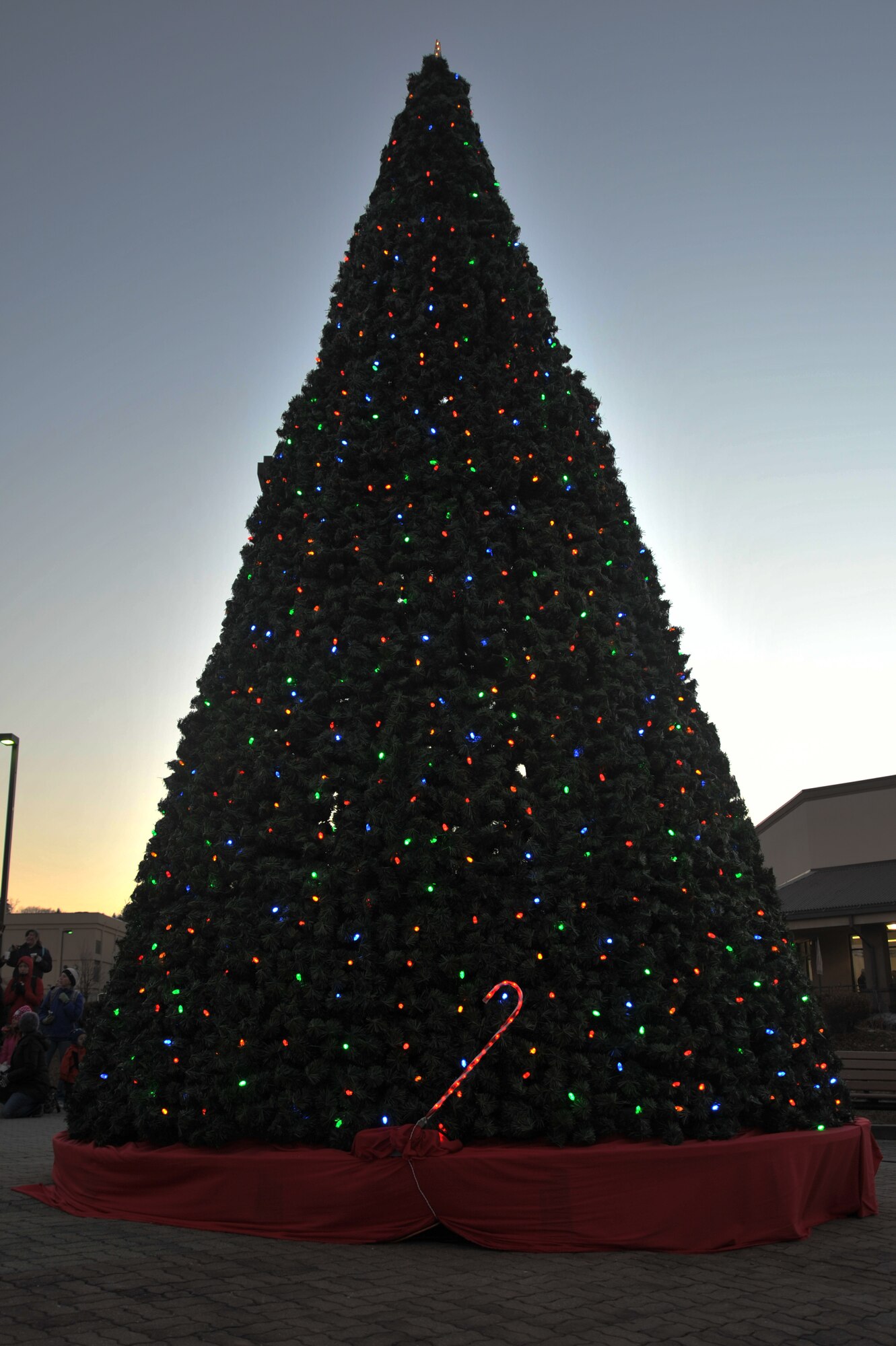 The base holiday tree is lit during the annual tree lighting ceremony at Osan Air Base, Republic of Korea, Nov. 26, 2012. This year’s events included an appearance from Santa Claus, music performances by the Osan American Elementary School students, and free hot chocolate and cookies. (U.S. Air Force photo/Staff Sgt. Craig Cisek)