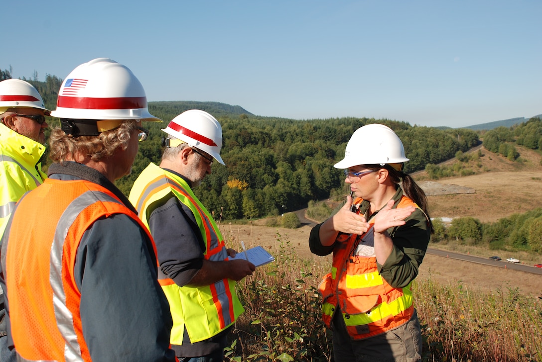 LKE owner Kim Erion explains the spillway raise project to LDN reporter Andre Stepankowsky and Corps project manager Tim Kuhn.  The U.S. Army Corps of Engineers and contractor LKE Corporation raise the spillway at the Mount St. Helens Sediment Retention Structure by nearly 10 feet. The spillway raise project will trap sediment in the Toutle River before it flows downstream.