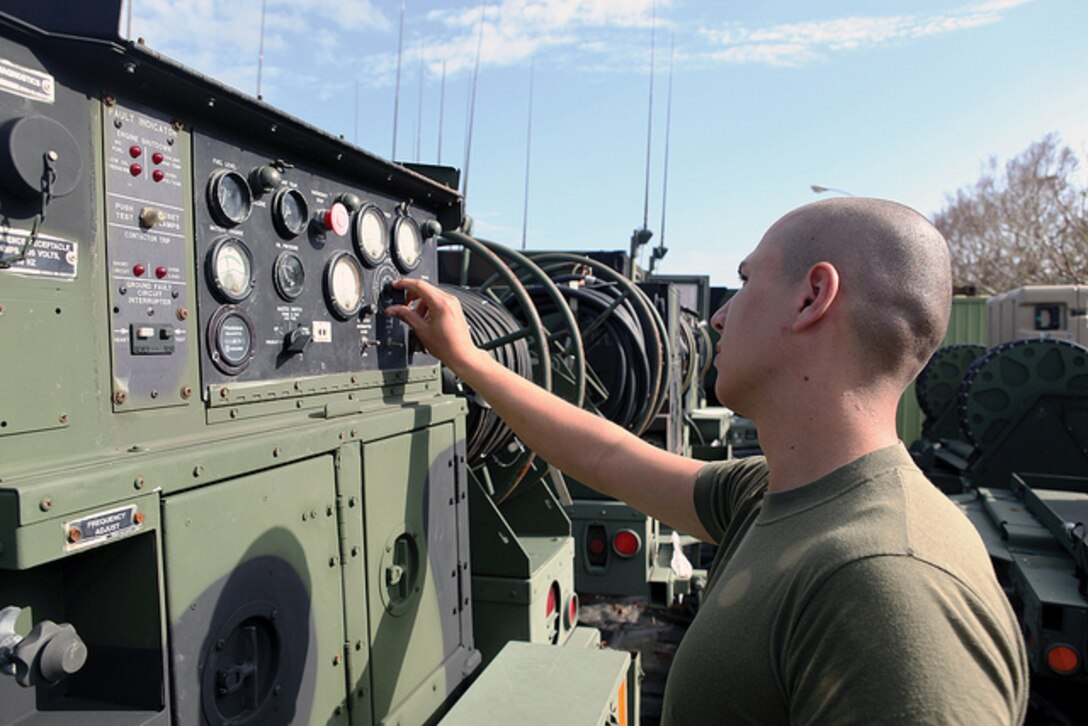 Lance Cpl. Enrique Gallardo sets up a communication interface system at Camp Foster Nov. 6. In May, Gallardo flew to San Diego to donate bone marrow to a woman suffering from acute lymphoblastic leukemia. Gallardo volunteered to be a donor during recruit training and was contacted as a potential match two years later. Gallardo is an aviation systems radio technician with Marine Air Support Squadron 2, Marine Air Control Group 18, 1st Marine Aircraft Wing, III Marine Expeditionary Force. (U.S. Marine Corps photo by Pfc. Kasey Peacock/Released)
