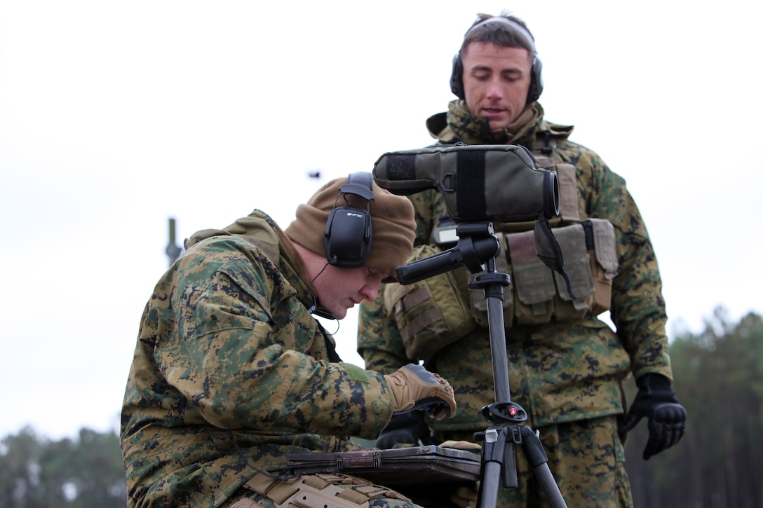Sgt. Nathaniel Hutt (right), a scout sniper, explains the spotter's job to Lance Cpl. Josh Cross, a small arms repair technician, both with Special-Purpose Marine Air-Ground Task Force Africa 13.2, during a field training exercise aboard Marine Corps Base Camp Lejeune, Nov. 16, 2012. To prepare for their upcoming deployment, 135 Marines from 32 different Reserve training centers came together to train and become familiar with each other.  (Marine Corps photo by Lance Cpl. Caleb McDonald/Released)