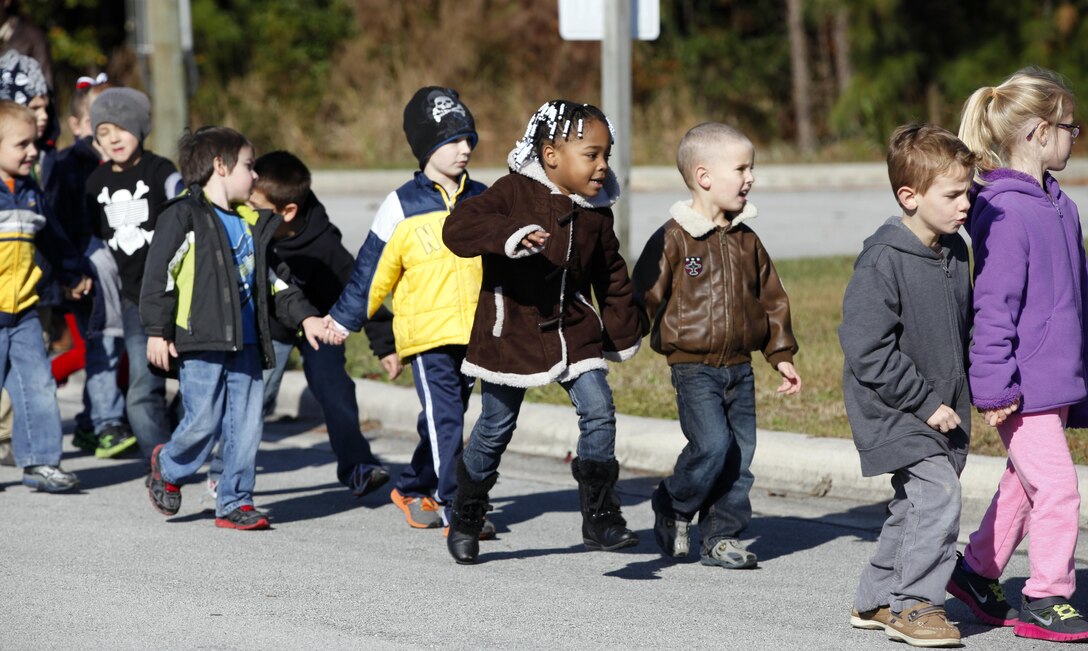 Students from Tarawa Terrace Elementary trot past as part of the annual Combined Federal Campaign walk aboard Marine Corps Base Camp Lejeune Nov. 16. The students raised more than $1,700 for the Wounded Warrior Family Support, Inc., exceeding their goal of just $1,000.