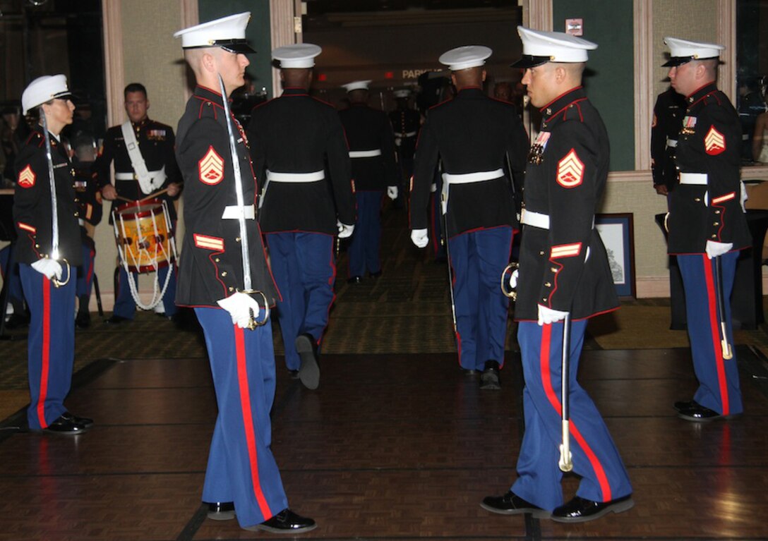 Staff Sergeants Timothy Cook, Canvassing Recruiter for RSS Daytona Beach, and Nelson Blanco, administrative chief for RS Jacksonville, face eachother and prepare to exit the stage during the culmination of the Station's 237th Marine Corps Ball pageant.