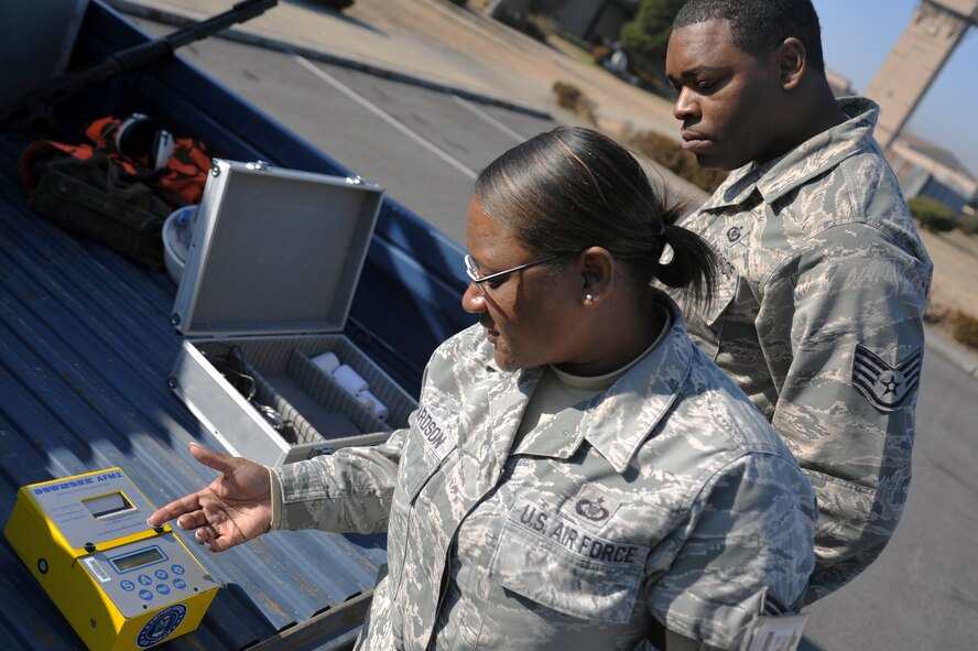 Tech. Sgt. Elizabeth Richardson, 51st Operations Support Squadron NCO in charge of airfield management operations, and Staff Sgt. Jerron Johnson, 51st OSS airfield management operations supervisor, use the Bowmonk machine at Osan Air Base, Republic of Korea, Nov. 27, 2012. The Bowmonk is used to test runway slickness when snow and ice is present. The test is conducted at all ramps and every 1,000 feet of the flight line. (U.S. Air Force photo/Staff Sgt. Craig Cisek)
