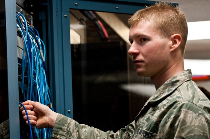Senior Airman Kyle Wilson, and Airman 1st Class Tyler Barrett, 99th Communication squadron network technicians, check network wire connections Nov. 20, 2012, at Nellis Air Force Base, Nev. The temperature in the network control center is maintained to keep the servers from overheating. (U.S. Air Force photo by Airman 1st Class Jason Couillard)