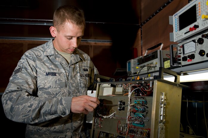 Senior Airman Stephen Massie, 99th Communications Squadron airfield systems technician, removes and replaces a component in a transmitter for the localizer Nov. 26, 2012, at Nellis Air Force Base, Nev. The 99th Communications Squadron maintains navigation aids, ground air radio, and weather systems. (U.S. Air Force photo by Airman 1st Class Christopher Tam)
