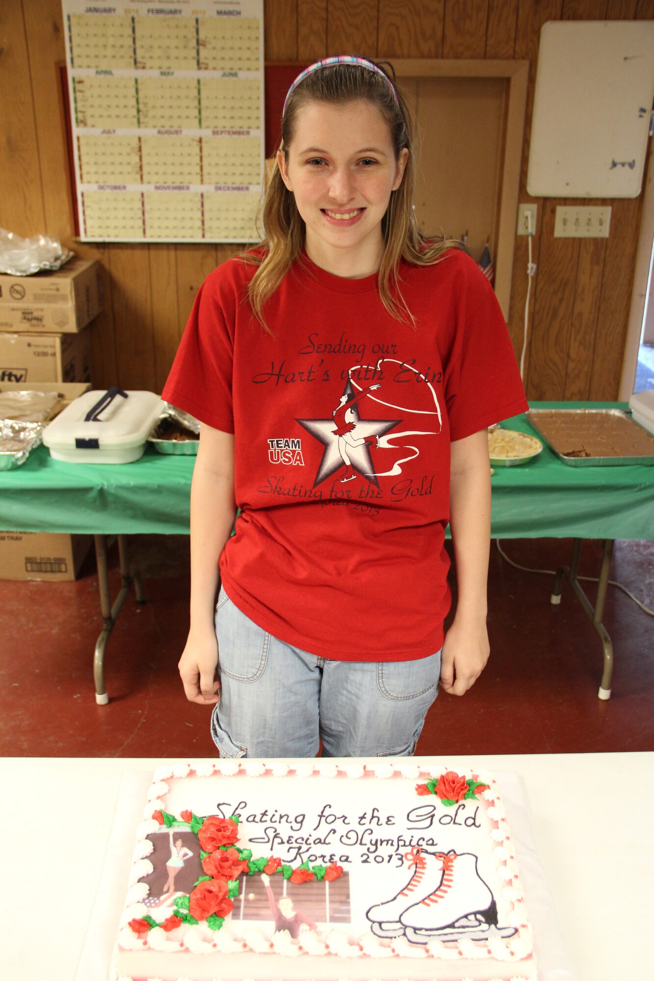 PLEASANT HILL, Ill. – Erin Hart, a senior at Pleasant Hill High School and daughter of Air Force Master Sgt. Rawnald Hart, 58th Airlift Squadron C-17 Globemaster III Loadmaster instructor at Altus Air Force Base, Okla. and Mrs. Kathy Hart, poses for a photo during a bake sale. Erin, who has mid-to-high functioning autism, started figure skating lessons approximately one year ago, and will be one of 11 athletes to compete in the Special Olympics World Winter Games in Pyeong Chang, South Korea scheduled for Jan. 29-Feb. 5, 2013. (Courtesy photo)