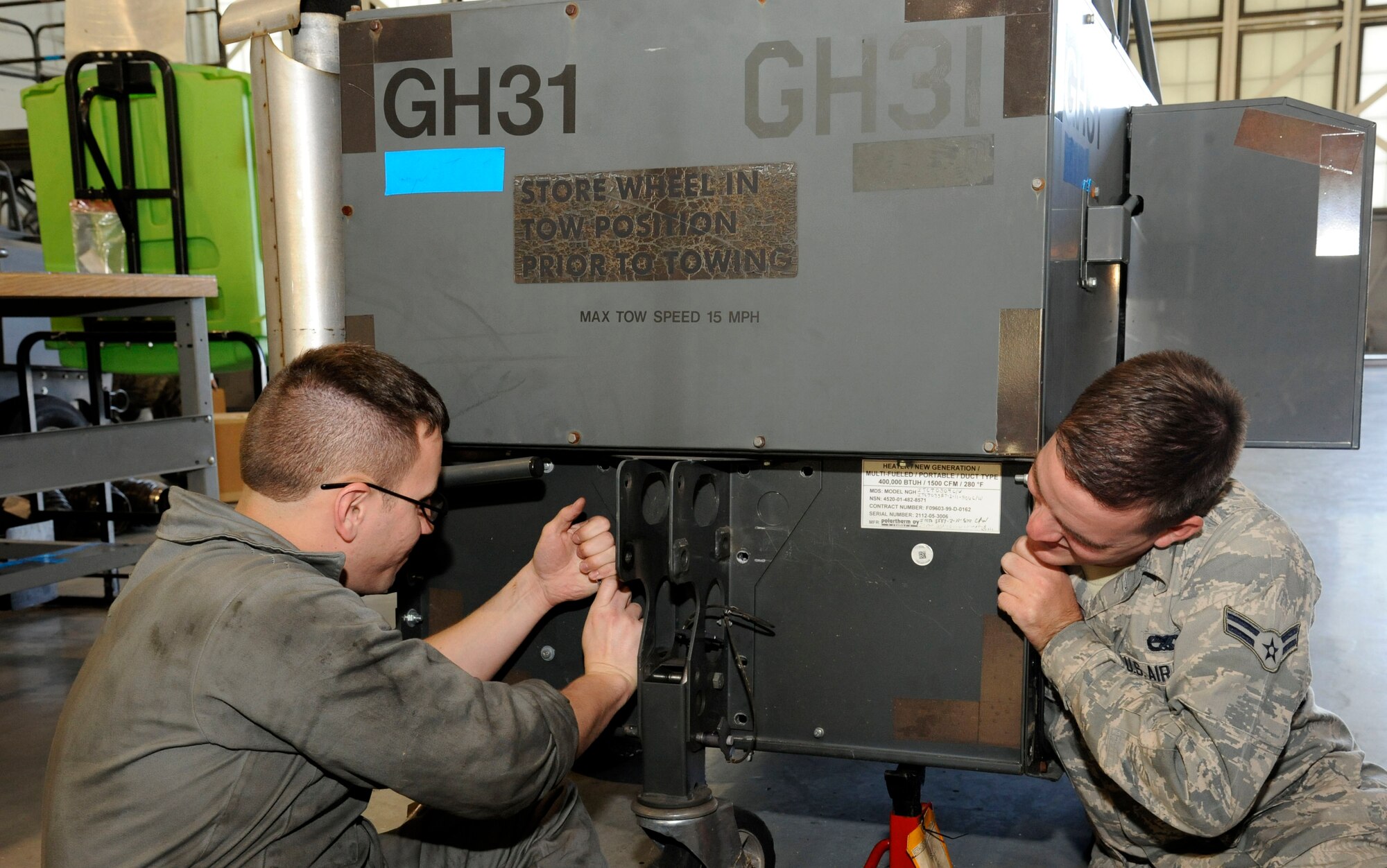 Airmen 1st Class Michael Herrera and Dylan Gandy, both of the 2nd Maintenance Squadron Aerospace Ground Equipment flight, comply with a time compliance technical order on Barksdale Air Force Base, La., Nov. 27. TCTOs modify equipment to make its use more convenient, and improve safety. (U.S. Air Force photo/Airman 1st Class Andrew Moua)(RELEASED)
