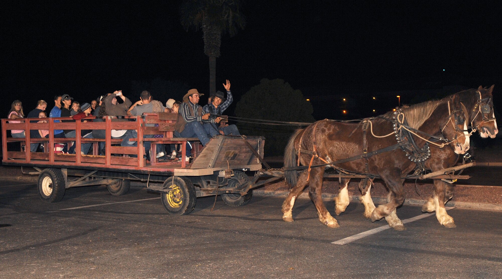 Members from around base go for a hayride at A Starry Snowy Southwest Night event at the chapel parking lot on Davis-Monthan Air Force Base, Ariz., Nov. 27. The event had many festivities, such as 50 tons of snow, hot chocolate, cookies, hayrides, a tree lighting, and photos with Santa. This year included skating rink for the children. (U.S. Air Force photo by Senior Airman Brittany Dowdle)