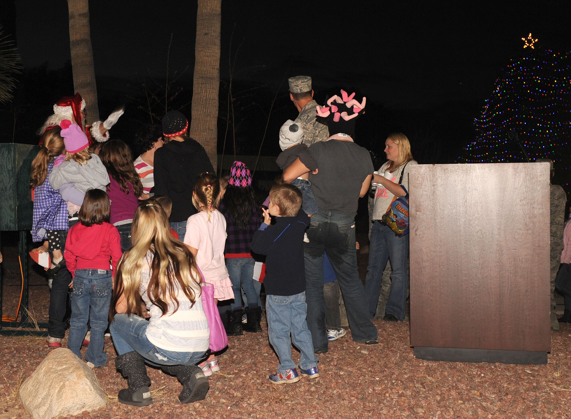 U.S. Air Force Col. James Meger, 355th Fighter Wing vice commander, invited children of deployed members to help Santa light the Christmas Tree at A Starry Snowy Southwest Night event in the chapel parking lot on Davis-Monthan Air Force Base, Ariz., Nov. 27. Several squadrons from around the base, along with off-base sponsors, helped put this event on for the base populous. (U.S. Air Force photo by Senior Airman Brittany Dowdle)