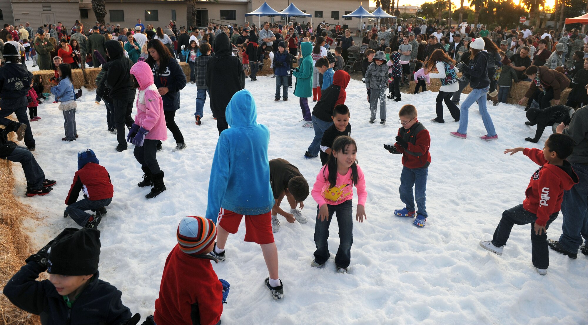 Children from around the base play in the 50 tons of snow at A Starry Snowy Southwest Night event in the chapel parking lot on Davis-Monthan Air Force Base, Ariz., Nov. 27. The event had many other festivities for children, such as hot chocolate, cookies, hayrides, a tree lighting, and photos with Santa. This year included a skating rink for the children. (U.S. Air Force photo by Senior Airman Brittany Dowdle)