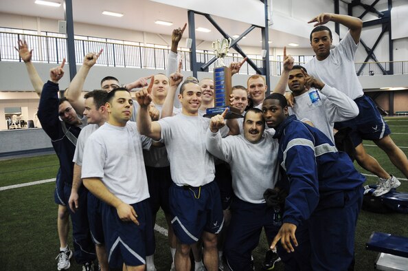 Members of the 354th Civil Engineer Squadron hold up the first place trophy as the champions of Sports Day Nov. 21, 2012, Eielson Air Force Base, Alaska. The 354th CES took the trophy after winning the most first place positions throughout the competition. (U.S. Air Force photo/Staff Sgt. Jim Araos)
