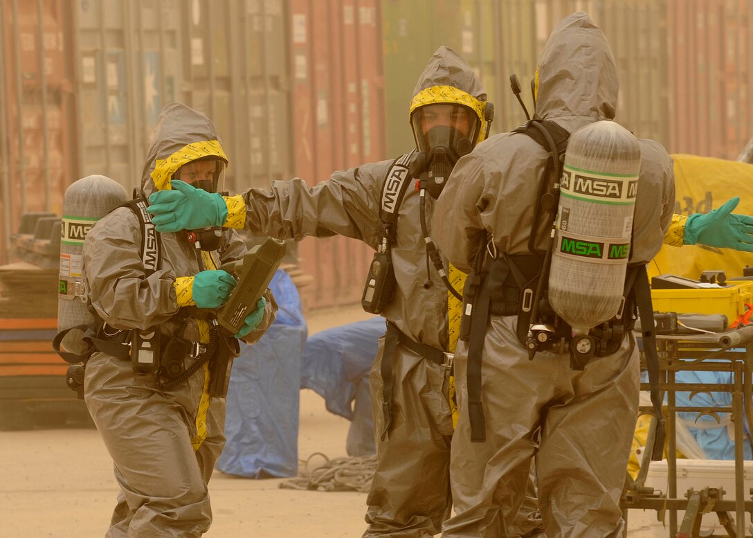 Senior Airman Amanda Heatherly (left), and Tech. Sgt. Joshua Ashby (right), scan Senior Airman Tyrone Fisher to make sure there are no hazardous material contamination on him at Camp Stryker, Iraq  on April 24, 2009. The inspection process is a joint effort between the emergency management team, the fire department and biological engineers. Airman Heatherly is deployed from the 117th Air Refueling Wing. (U.S. Air Force photo by Senior Airman Jacqueline Romero)