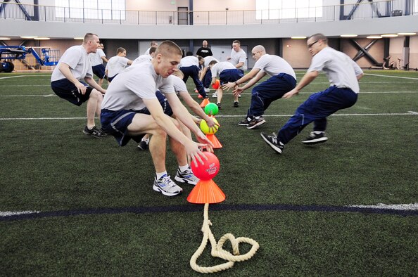 Members of the 354th Operations Support Squadron and 354th Logistics Readiness Squadron square off in a dodgeball competition during Sports Day Nov. 21, 2012, Eielson Air Force Base, Alaska. The annual event gave Airmen the opportunity to participate in several individual and team sports throughout the day boosting team morale. (U.S. Air Force photo/Staff Sgt. Jim Araos)