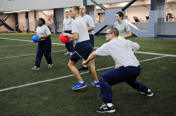 Members of the 354th Operations Support Squadron prepare to launch dodgeballs during Sports Day Nov. 21, 2012, Eielson Air Force Base, Alaska. Sports Day was designed to improve teamwork, boost morale and help increase the awareness of fitness and sports. (U.S. Air Force photo/Staff Sgt. Jim Araos)