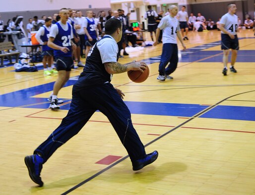Members of the 354th Fighter Wing participate in a basketball competition during Sports Day Nov. 21, 2012, Eielson Air Force Base, Alaska. Sports Day included flag football, volleyball, a 1-mile race, basketball, tug-o-war and dodgeball.  (U.S. Air Force photo/Staff Sgt. Jim Araos)