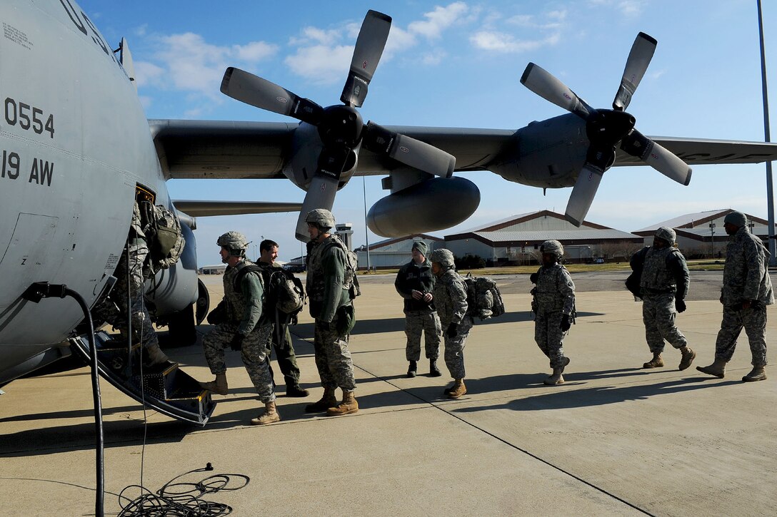 Service members assigned to the 689th Rapid Port Opening Element board a C-130 during a U.S. Transportation Command Joint Task Force - Port Opening exercise at Langley Air Force Base, Va., Nov. 28, 2012. The 689th RPOE and TRANSCOM conducted the two-day exercise to assess response time and preparation of an airfield in the case of a national disaster. (U.S. Air Force photo by Staff Sgt. Ashley Hawkins/Released)