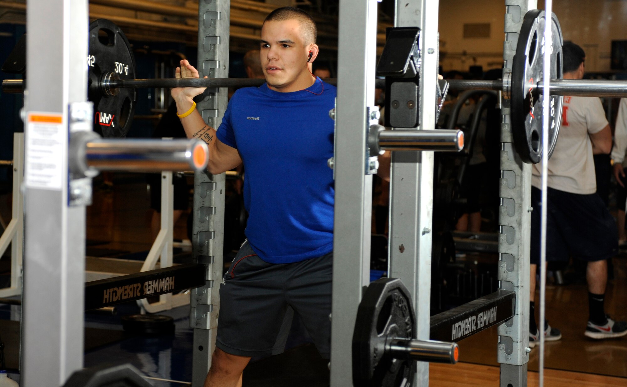 Airman 1st Class Brandon Stout, 28th Civil Engineer Squadron Fire Department driver operator, shoulders 135 pounds while warming up for a squat during Ellsworth's Strongest in the Bellamy Fitness Center at Ellsworth Air Force Base, S.D., Nov. 16, 2012. To avoid damage to muscles and other areas of the body, participants were given 15 minutes to warm up before the competition began. (U.S. Air Force photo by Airman Ashley J. Woolridge/Released)