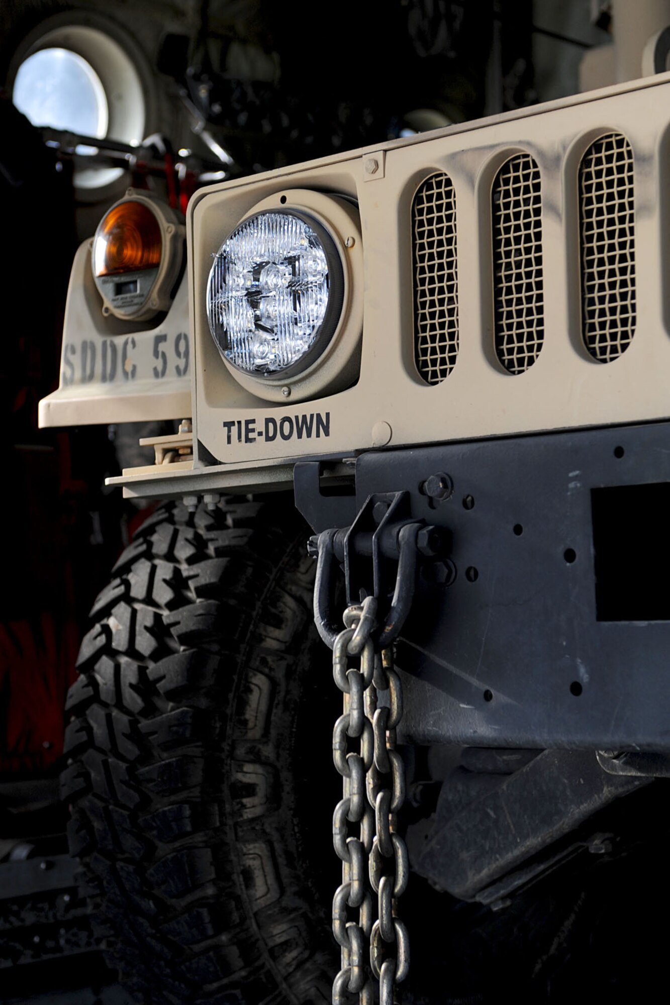 A Humvee is prepped to be tied down to a C-130 during a U.S. Transportation Command Joint Task Force - Port Opening exercise at Langley Air Force Base, Va., Nov. 28, 2012. This is the first time the annual exercise has been fully assessed to evaluate the response time, loading and opening of an airport in an alternate location to fit the needs of a humanitarian relief. (U.S. Air Force photo by Staff Sgt. Ashley Hawkins/Released)