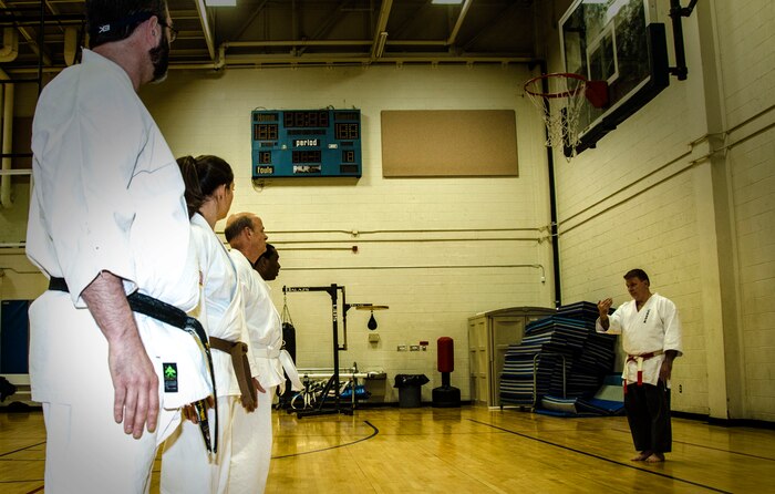 Tim Boykin, Space and Naval Warfare Systems operations research analyst and retired Navy commander, trains service members and civilians in martial arts Nov. 26, 2012, at the Joint Base Charleston – Air Base fitness center. Before practicing striking moves, Boykin conducts cardio exercises and warm-ups with the group. (U.S. Air Force Photo / Airman 1st Class Tom Brading)