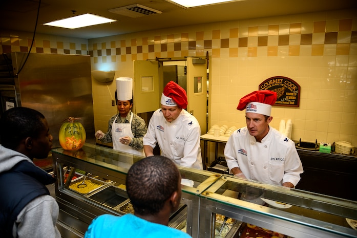 Master Sgt. Jadirra Walls, 437th Maintenance Squadron first sergeant (left), Col. Darren Hartford, 437th Airlift Wing commander (center), and Col. James  Fontanella, 315th Airlift Wing commander), serve Thanksgiving dinner to Airmen at the Robert D. Gaylor dining facility, Nov. 24, 2012, at Joint Base Charleston - Air Base, S.C. Commanders, chiefs and their families took time to serve Thanksgiving dinner to their fellow Airmen and retirees. (U.S. Air Force photo/Staff Sgt. Rasheen Douglas)