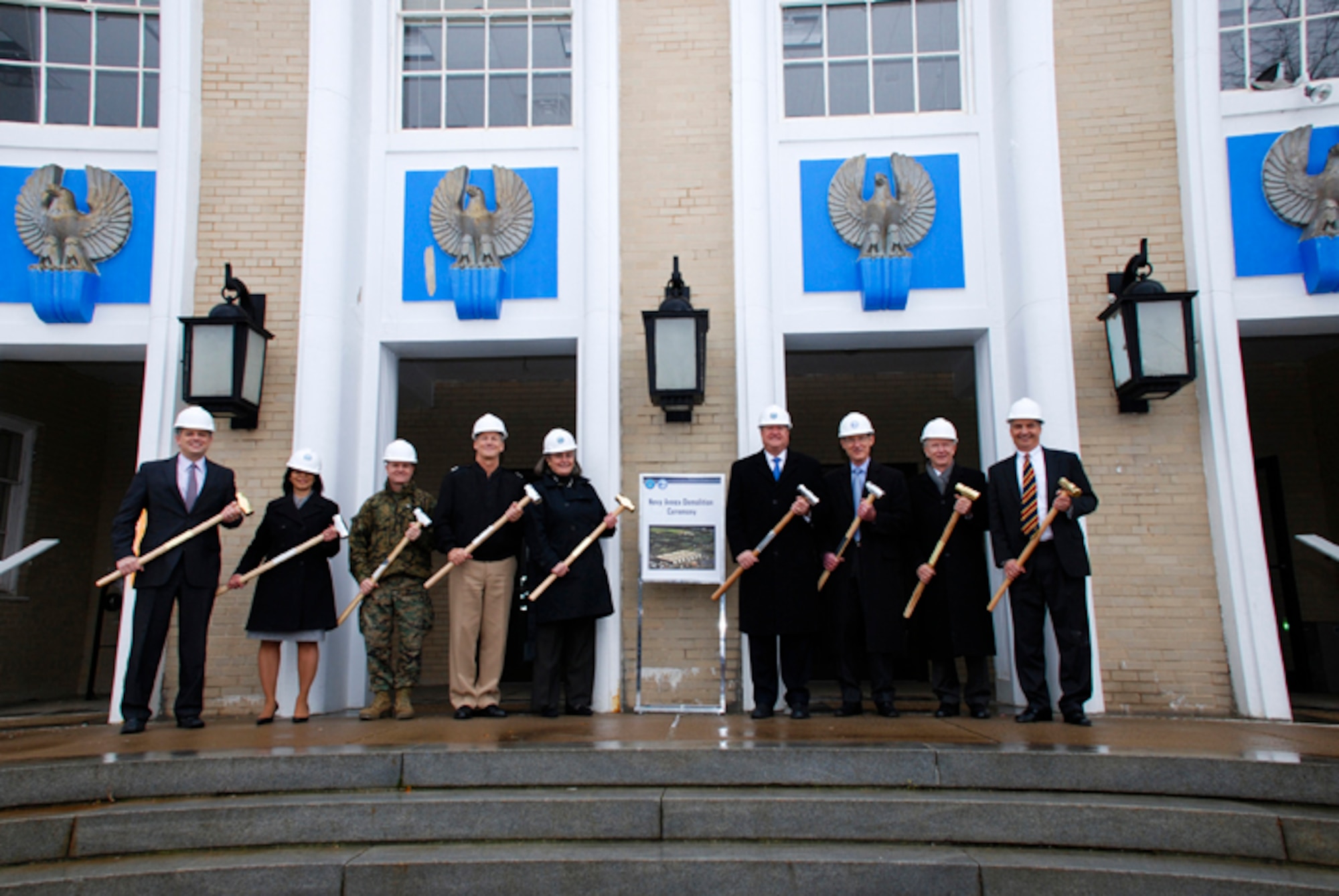 Department of Defense senior leaders attended a ceremony to commemorate the history of the Navy Annex building by Arlington National Cemetery and the Air Force Memorial and mark the start of its demolition process. Pictured, left to right, are Michael Rhodes, director of Administration and Management; Joan Hughes, director, Operations Directorate, Office of the Department of the Navy Assistant for Administration; Col. Aaron Amey, assistant chief of staff for Logistics for the Marine Corps Installations Command; Rear Admiral Robert Thomas, chief of staff, J5, The Joint Staff; Kathryn Condon, executive director of Army National Cemeteries Program, Michael Donley, secretary of the Air Force; Thomas Hawley, deputy under secretary of the Army; Steven Redmann, executive director, U.S. Army Headquarters Services, Office of the Administrative Assistant to the Secretary of the Army. In accordance with the fiscal year 2000 Defense Authorization Act, 42 acres of land will be transferred to the Department of the Army for future use by the cemetery. The 70 year-old annex building was originally built as a warehouse in 1941 and has housed Marine Corps headquarters and many Navy offices through the years. (Courtesy Photo)