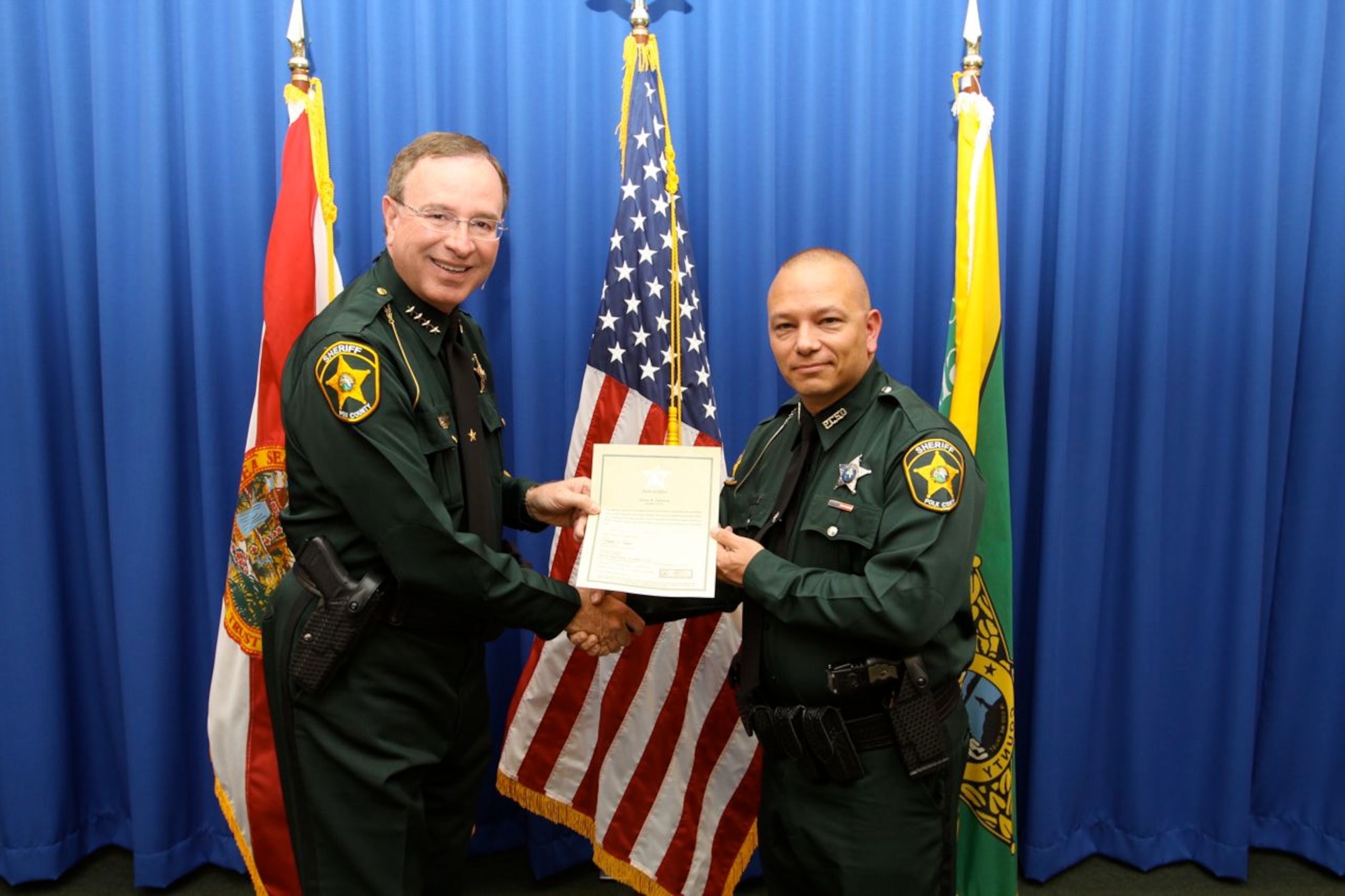U.S. Air Force Staff Sgt. Steven Jefferson, 23d Wing Det. 1 Avon Park ground safety manager, receives his oath from Sheriff Grady Judd Nov. 1, 2012. Jefferson is on active duty in the U.S. Air Force and works part time as a deputy sheriff for the Polk County Sheriff's Office in Southeast District, Lake Wales, Fla. (U.S. Air Force photo by Airman 1st Class Jarrod Grammel/Released)