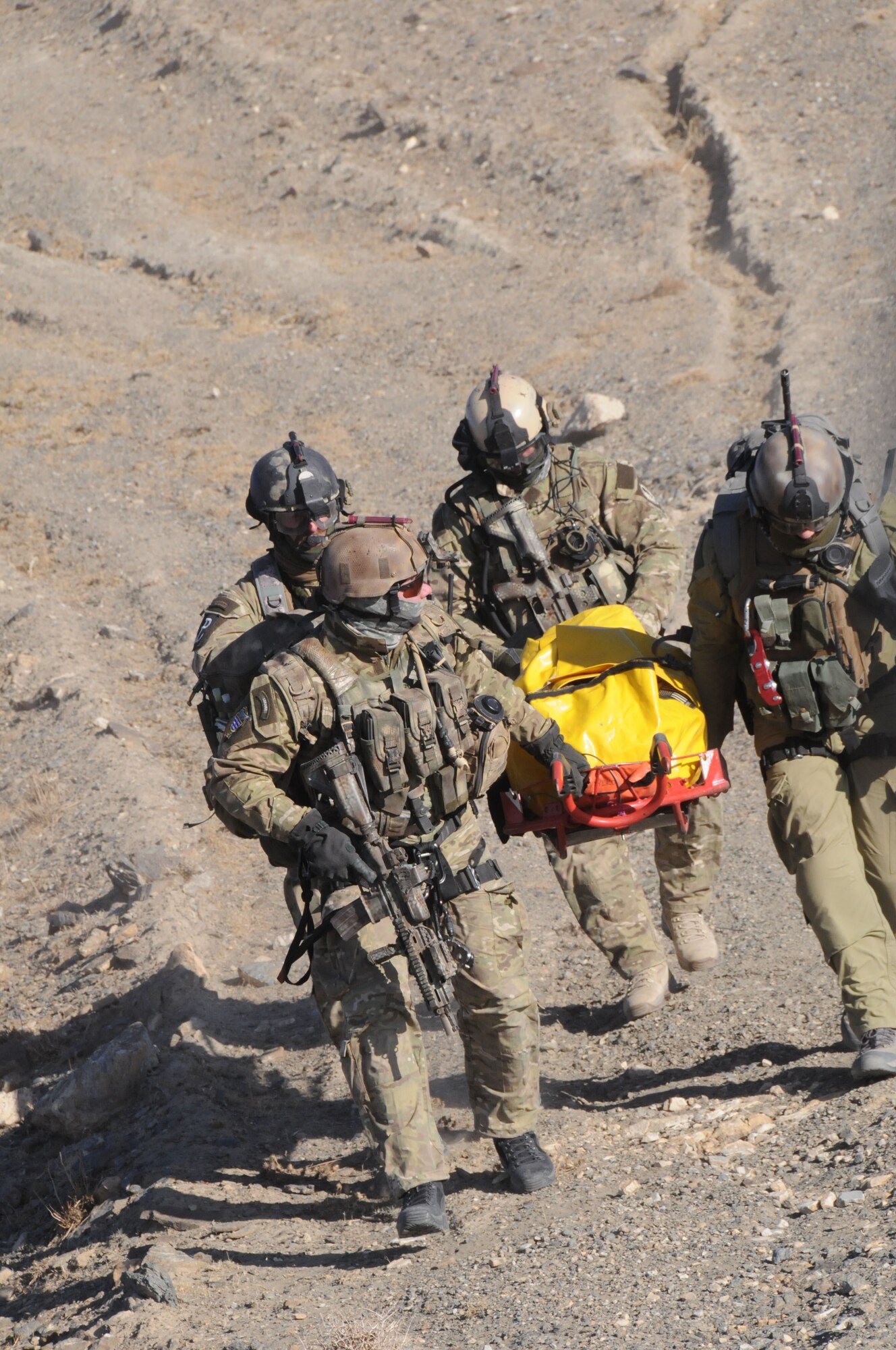 Members of the Polish Special Forces carry a "casualty" up the side of a mountain during 9-line training in Ghazni, Afghanistan on Dec. 7, 2009.  The Polish medics and Special Forces along with U.S. Army personnel trained on 9-line medevac rescue on the side of a mountain inside the Ghazni Province.  (U.S. Air Force/Tech Sgt. Rebecca F. Corey, PRT Ghazni)