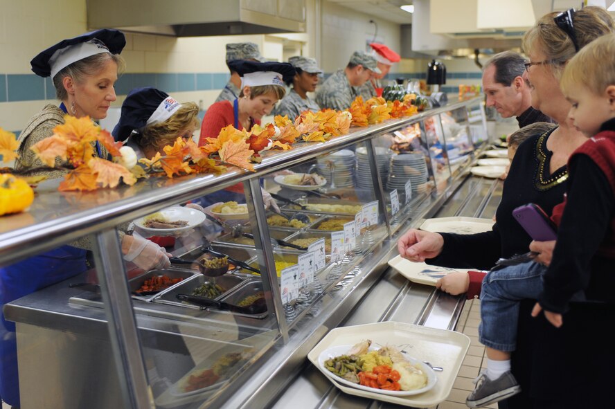 Wing leaders and their spouses prepare meals for members of Team Seymour at the Southern Eagle Dining Facility on Seymour Johnson Air Force Base, N.C., Nov. 22, 2012. They served more than 100 people a Thanksgiving meal during the event. (U.S. Air Force photo/Airman 1st Class John Nieves Camacho/Released)