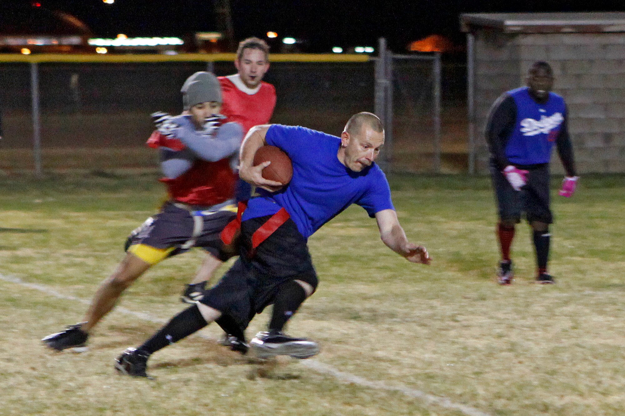 Mike Warren, 412th Civil Engineer Division, attempts to run in a touchdown for the 412th Medical Group team during the second half of an intramural football playoff game against the 412th Electronic Warfare Group team Nov. 27, 2012 at Wings Field. The 412th MDG defeated the 412th EW team 40-12. The final championship game will be played Nov. 29, 2012 at 5:15 p.m. on Wings Field. (U.S. Air Force photo by Jet Fabara)