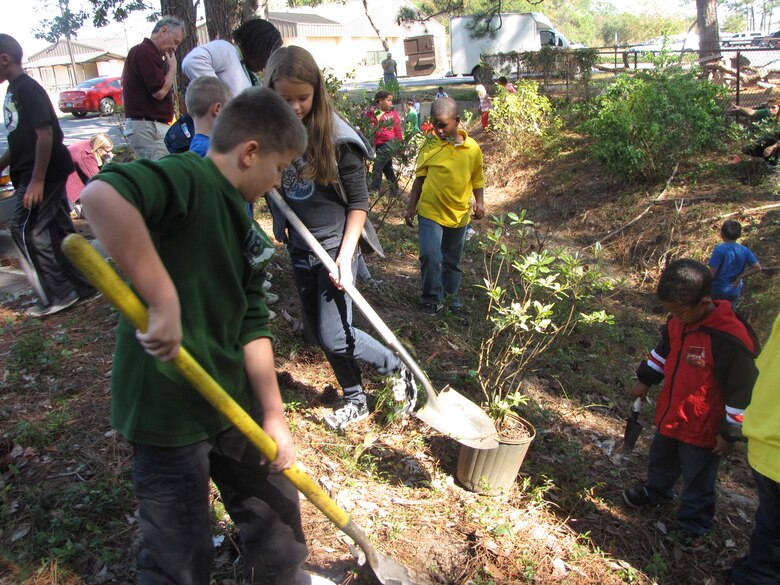 Children use shovels to strengthen the stream during the Hurlburt Field Youth Center Wetland Stream Project at Hurlburt Field, Fla.  The success of the project was due, in large part, by the children of the Hurlburt field Child Development Center and Youth Center.   (Courtesy photo by Catherine Goss)