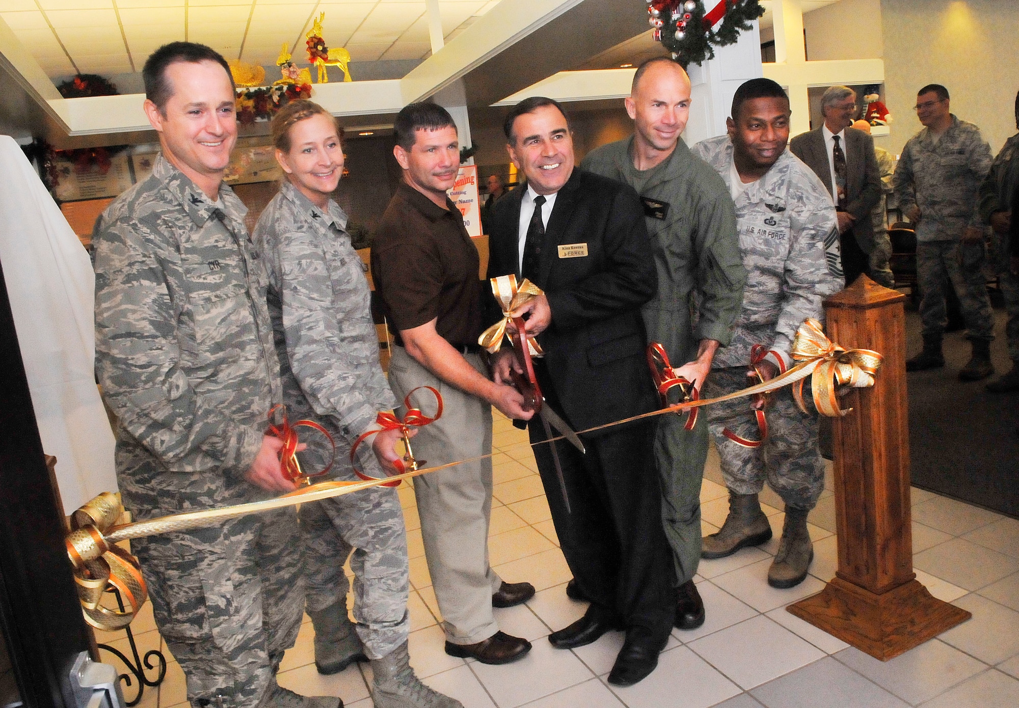 Col. Henry  Cyr, Col. Patricia Ross, Jon King, Alexander Kovras, Lt.Col. David Steele, and Chief Master Sgt. Lorenzo Anastasie cut the ribbon for "The Quick Turn", the 78th Force Support Squadron’s newest food operation in Bldg. 2062. (U. S. Air Force photo/Sue Sapp)
