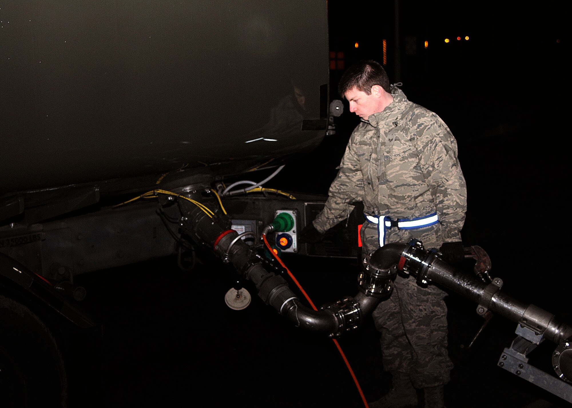 Senior Airman Dillon Moore, 100th Logistics Readiness Squadron fuels apprentice from Reno, Nev., prepares to refuel an R-11 refueler truck Nov. 27, 2012, on the flightline at RAF Mildenhall, England. The R-11 is used to pass fuel to planes and can hold up to 6,000 gallons of jet fuel. (U.S. Air Force photo by Airman 1st Class Kelsey Waters/Released)