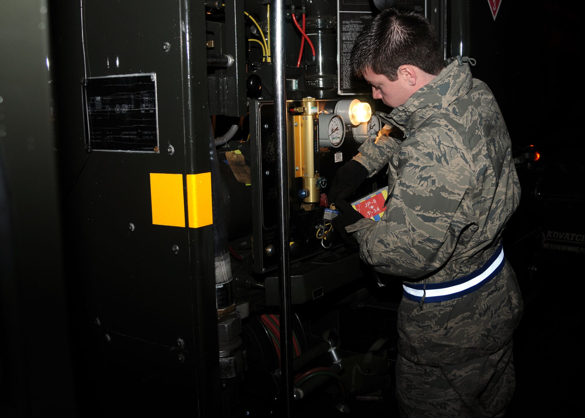 Senior Airman Dillon Moore, 100th Logistics Readiness Squadron fuels apprentice from Reno, Nev., checks over an R-11 refueler truck as he prepares to refuel a KC-135 Stratotanker Nov. 27, 2012, on the flightline at RAF Mildenhall, England. The R-11 is used to pass fuel to planes and can hold up to 6,000 gallons of jet fuel. (U.S. Air Force photo by Airman 1st Class Kelsey Waters/Released)