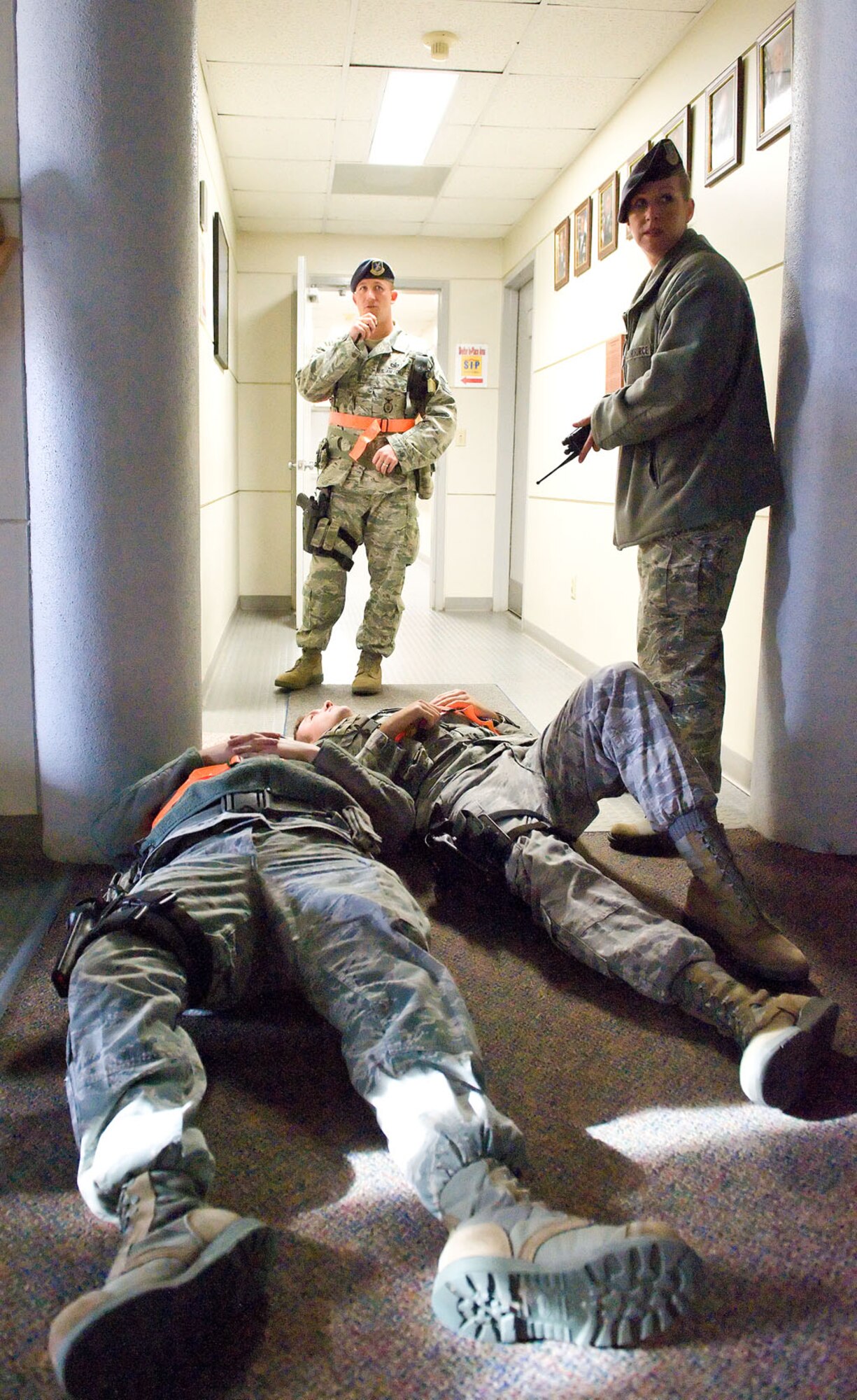 Tech. Sgts. Frederick Quick, left, and Lynn Lujan, both from the 436th Security Forces Squadron, report simulated casualties from a simulated active shooter during the Major Accident Response Exercise Nov. 15, 2012, at Dover Air Force Base, Del., at building 600. The MARE tested Team Dover's ability to respond to simulated incidents on base. (U.S. Air Force photo by Roland Balik)