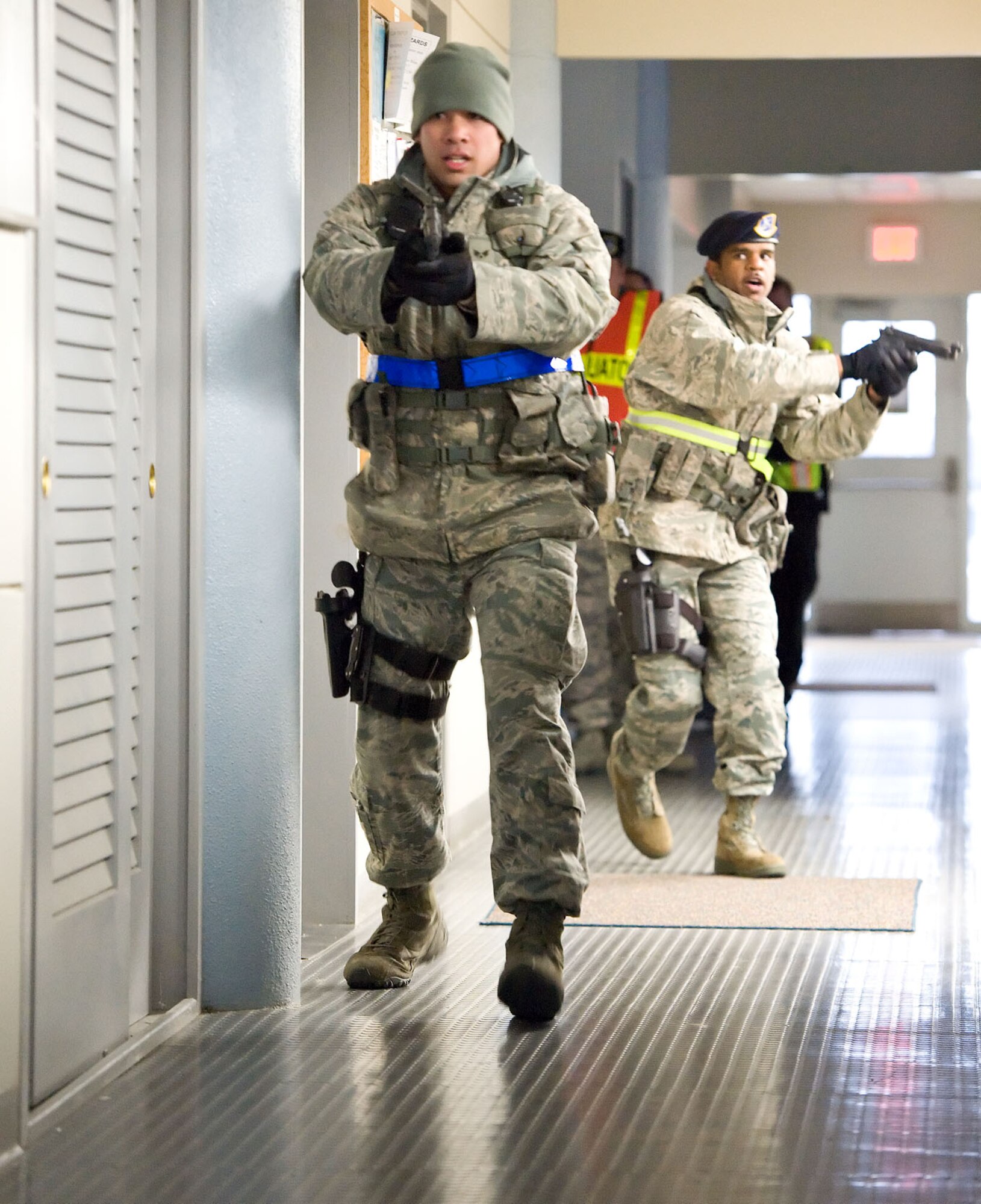 Senior Airman Steven Tayfel, left, and Staff Sgt. Anthony Leonard, both from the 436th Security Forces Squadron, sweep a building during the Major Accident Response Exercise Nov. 15, 2012, at Dover Air Force Base, Del., at building 600. The MARE tested Team Dover's ability to respond to simulated incidents on base. (U.S. Air Force photo by Roland Balik)