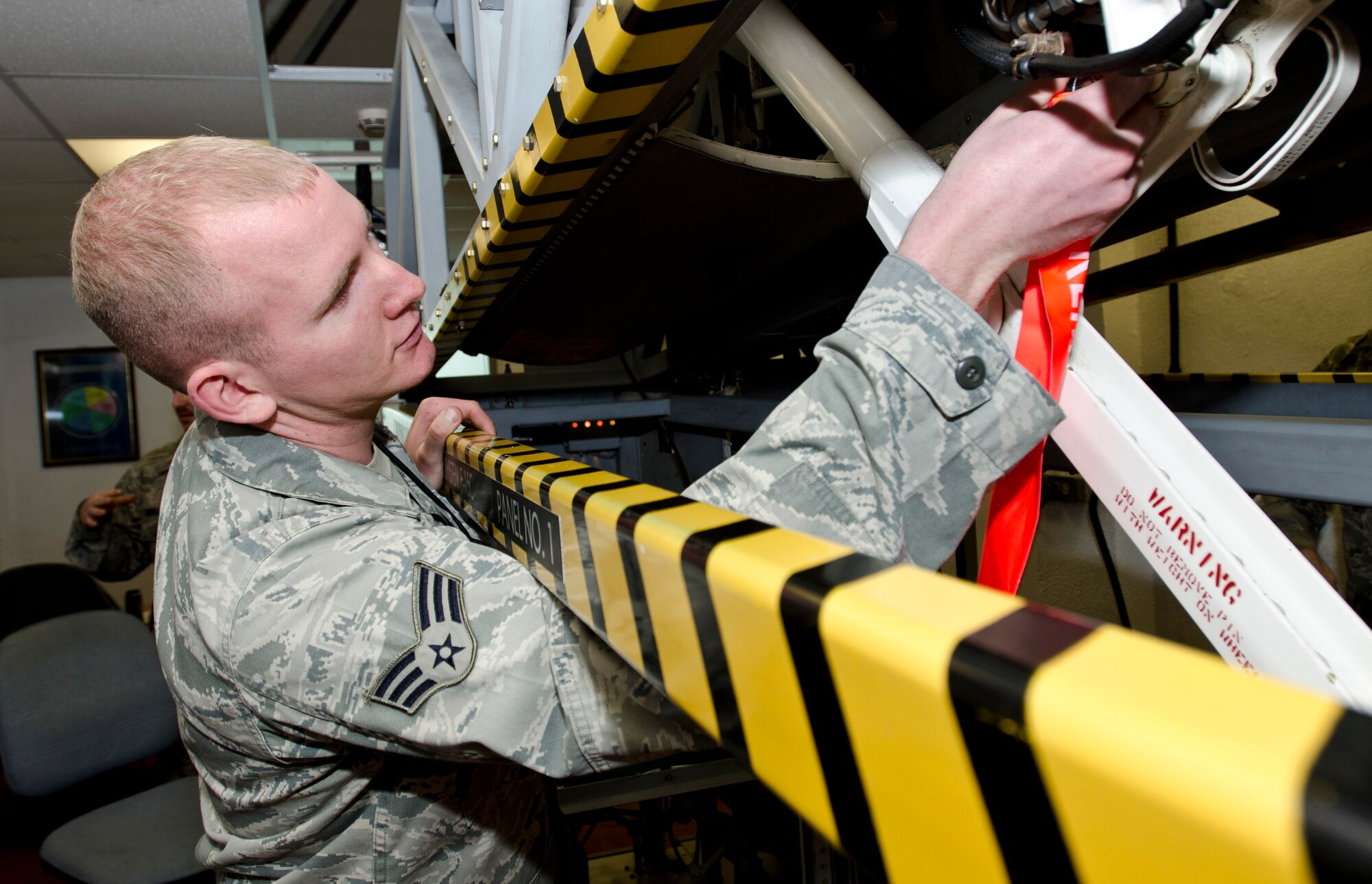 ROYAL AIR FORCE LAKENHEATH, England - Senior Airman Joseph Schlotthauer, 493rd Aircraft Maintenance Unit tactical aircraft maintenance journeyman and native of Lancaster, Pa., inserts a pin on a landing gear trainer during an F-15 hydraulics course Nov. 27, 2012. Detachment 16 recently acquired the landing gear trainer from Sheppard Air Force Base, Texas. The trainer replaces the need to use an actual aircraft, reduces man-hours associated with the course and provides students with a better training environment. (U.S. Air Force photo by Staff Sgt. Stephen Linch)
