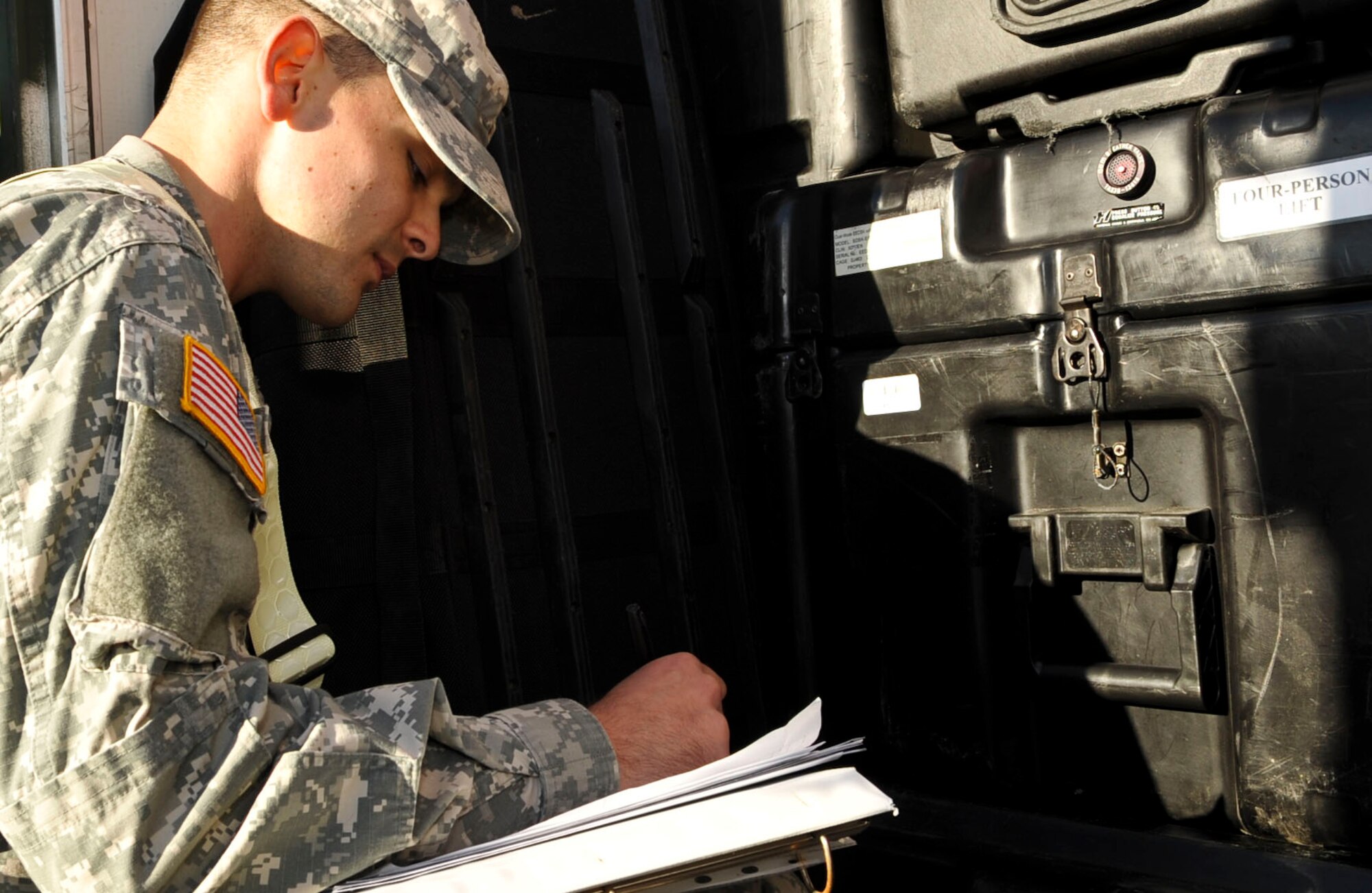 U.S. Army Spc. Michael Visser, 690th Rapid Port Opening Element cargo specialist, inspects cargo in a shipping container at the motor pool at Fort Eustis, Va., Nov. 26, 2012. Visser joined the Army in 2010 to escape the pitfalls of drug abuse among his parents, and found success in the military. (U.S. Air Force photo by Staff Sgt. Wesley Farnsworth/Released)