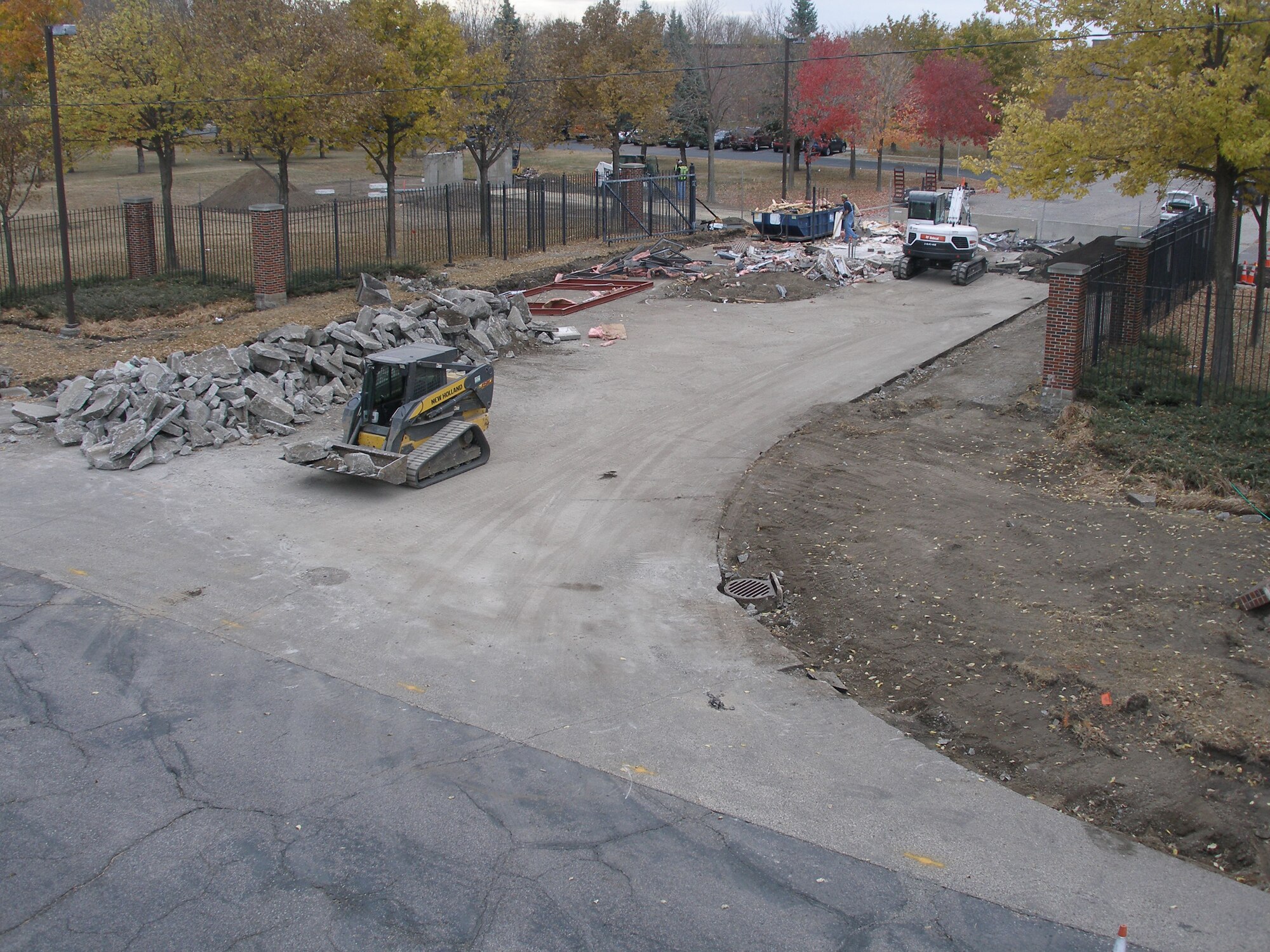 Final demolition is performed on the previous 934th Airlift Wing gate near highway 62 Oct. 17. A new wall will be constructed to provide the exterior with an integrated seamless appearance. (Air Force Photo/Master Sgt. Joe Wiatros)