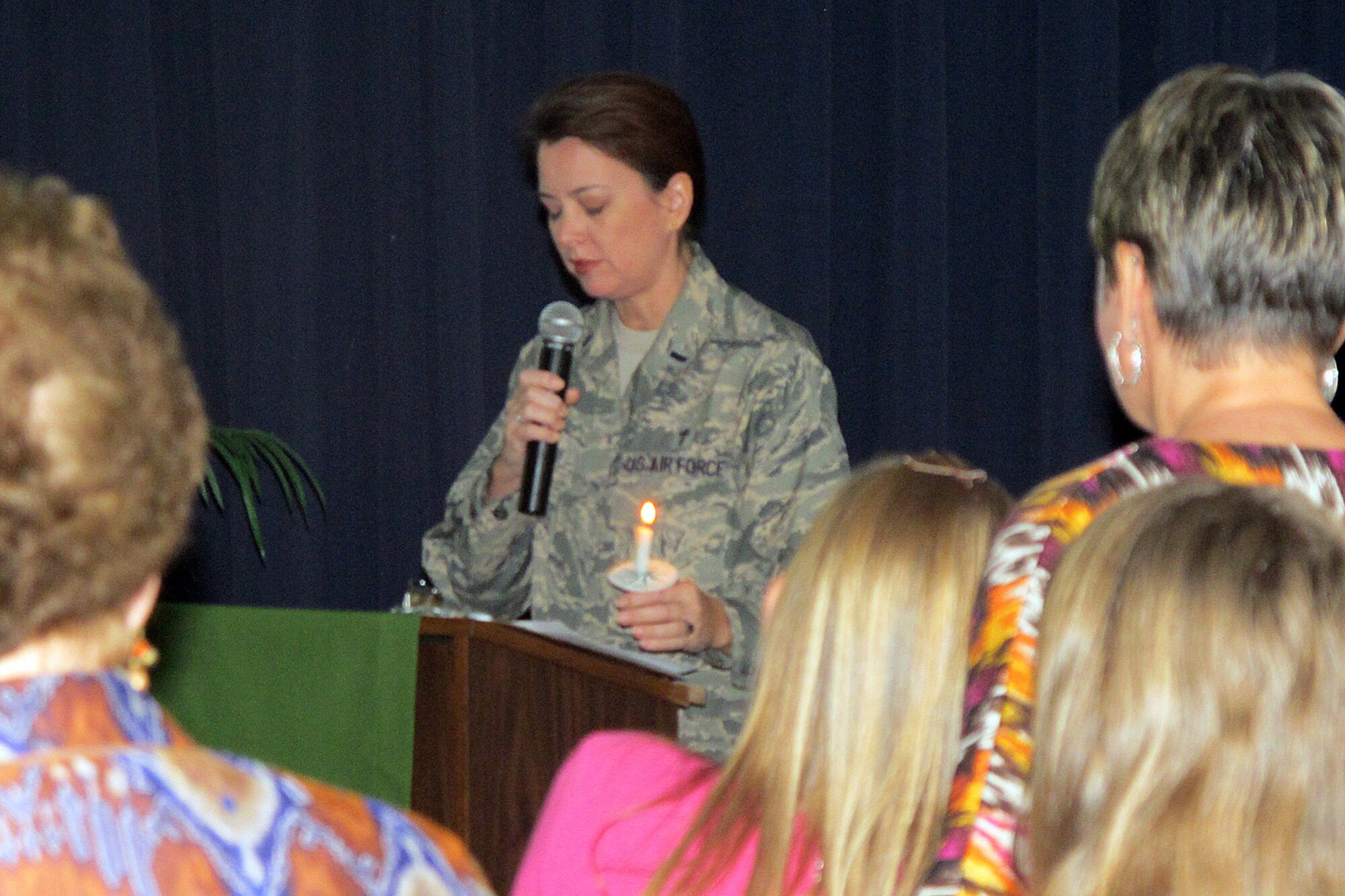 1st Lt. Christina Pittman, a Chaplain with the 169th Fighter Wing, prays during the First Annual Remembrance Service on November 4, 2012 at McEntire Joint National Guard Base. This interfaith service was organized by McEntire?s Chaplain?s Corps and included words of inspiration, prayers and reflection as the Swamp Fox family remembers friends and loved ones.
(SCANG photo by Lt.Col. Jim St.Clair/Released)
