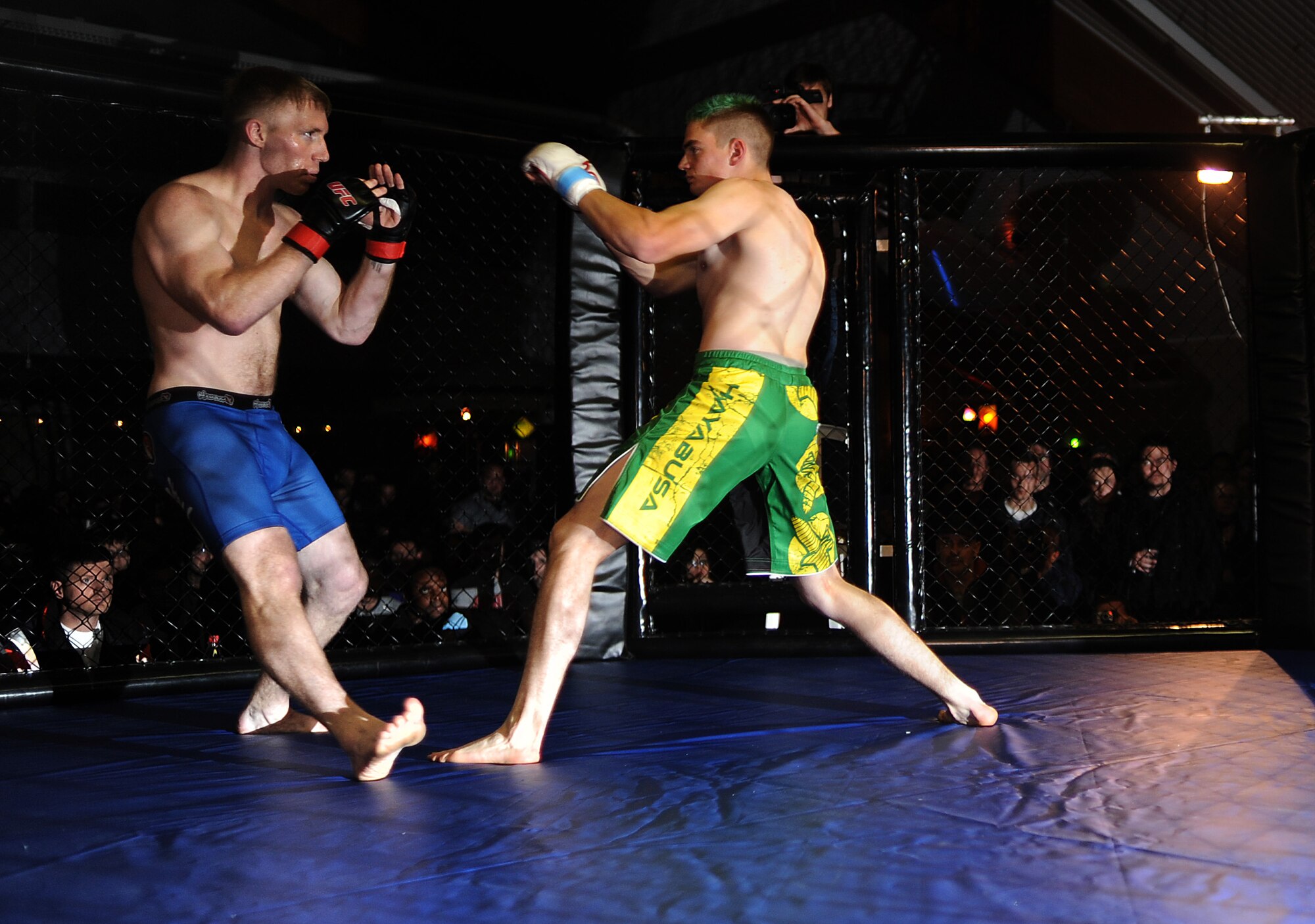 BAUMHOLDER, Germany -- Airman 1st Class Sean Whitaker, left, Spangdahlem mixed martial arts team member from Pittsburgh, fights in his first cage fight Nov. 17, 2012, at Kombat Komplett 7 in Baumholder. Kombat Komplett 7 is a German MMA event in which members of various nations participate. Whitaker, a member of Spangdahlem Air Base, faced off against a local national in his first fight. (U.S. Air Force photo by Senior Airman Natasha Stannard/Released)