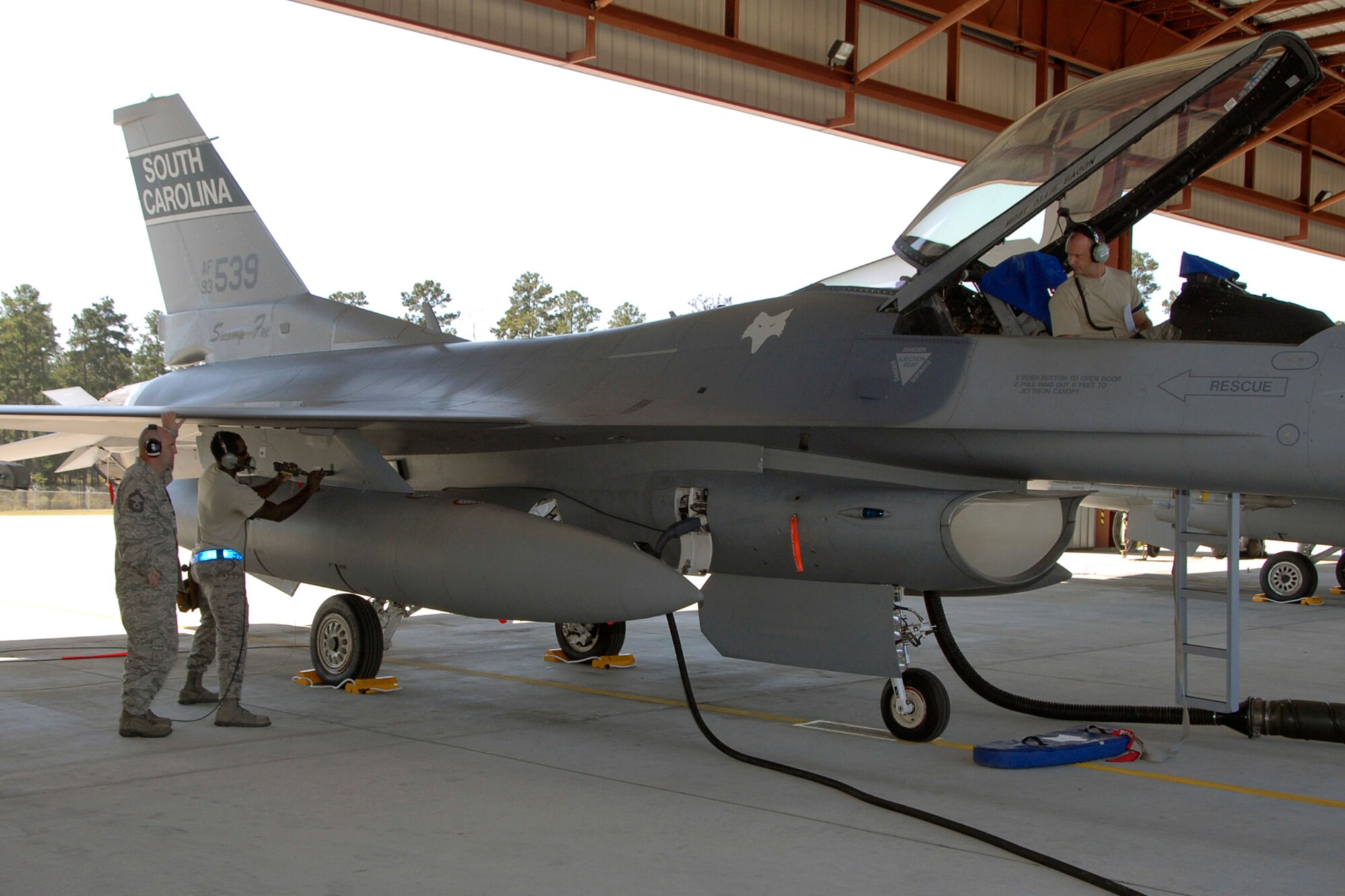 Senior Master Sgt. Brian Norris, a weapons inspector assigned to 1st AF from Tyndall Air Force Base, Fl., evaluates the 169th Fighter Wing's weapons load team during a weapons reliability check.  The McEntire team consists of Master Sgt. Jeremy Pow, team leader, and Senior Airmen Steven Hollis and Carlos Graham, all assigned to the 169th Fighter Wing's Aerospace Control Alert unit.  McEntire Joint National Guard Base's Aerospace Control Alert mission receives an AFOA inspection from 1AF/AFNORTH, Sept. 26, 2012.  McEntire is home of the Swamp Foxes of the South Carolina Air National Guard and the 169th Fighter Wing.  (National Guard Photo by Senior Master Sgt. Edward E. Snyder / Released)                           