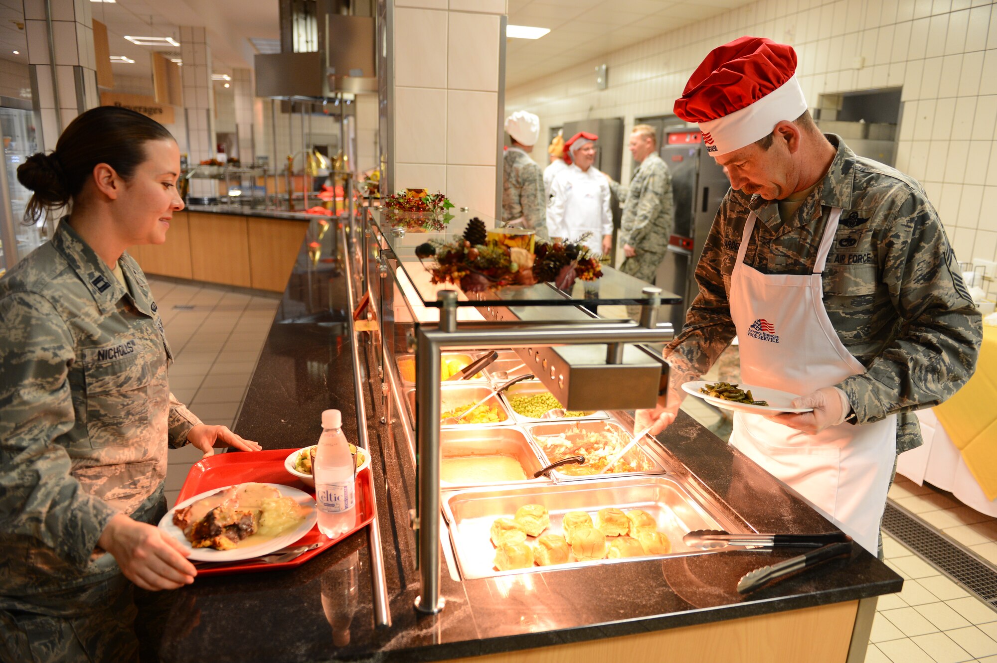 SPANGDAHLEM AIR BASE, Germany – U.S. Air Force Chief Master Sgt. William Wardell, 52nd Operations Group superintendent from Brick, N.J., serves a plate of vegetables to Capt. Kirsten Nicholls, 52nd Force Support Squadron Military Personnel Section chief from Palmdale, Calif., during the Thanksgiving meal inside the Mosel Hall Dining Facility Nov. 22, 2012. The facility hosted a holiday meal that allowed more than 200 Airmen and family members to enjoy a traditional meal served by leaders from around the base. (U.S. Air Force photo by Airman 1st Class Dillon Davis/Released)