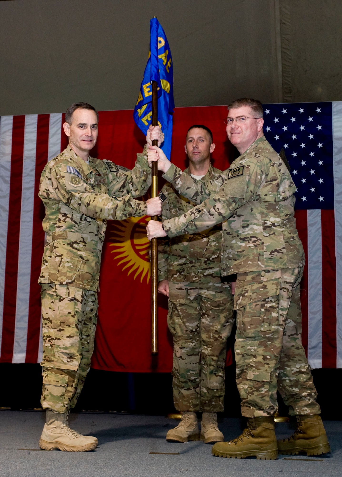 Maj. Gen. H.D. Polumbo Jr., left, 9th Air and Space Expeditionary Task
Force-Afghanistan commander, passes the newly activated 466th Air
Expeditionary Group's guideon to Col. John Cline, incoming commander, during
an activation and assumption of command ceremony, Transit Center at Manas,
Kyrgyzstan, Nov. 26, 2012. Cline assumed command of the 466 AEG whose
mission is to provide administrative support and accountability for more
than 2,300 Joint Expeditionary Tasking Airmen and individual augmentees
serving throughout Afghanistan. (U.S. Air Force photo/Senior Airman
Stephanie Rubi)
