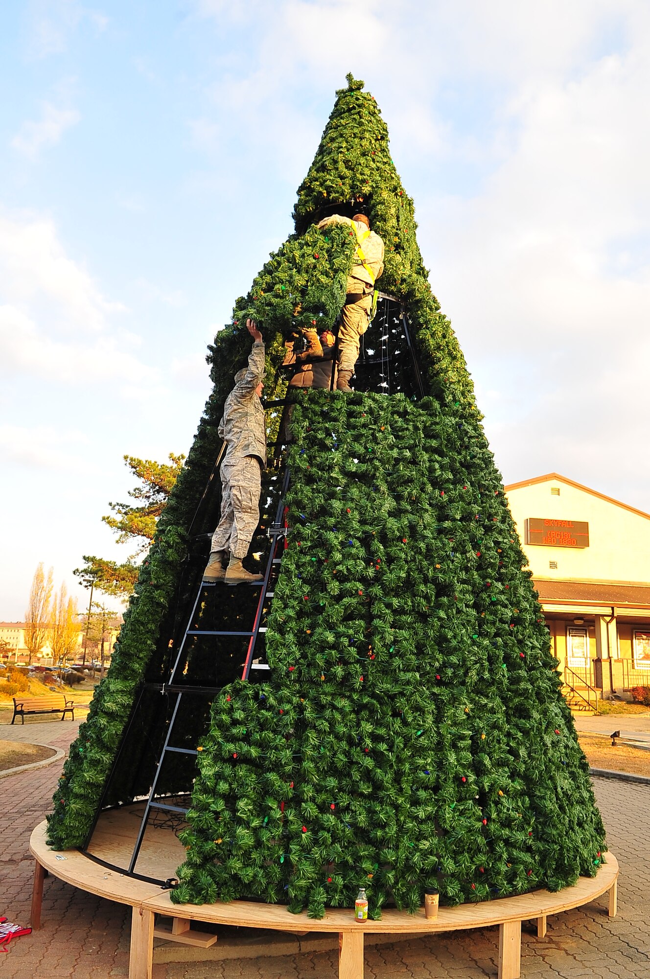 Airmen from the 51st Civil Engineer Squadron secure segments of the base holiday tree to its framework at Osan Air Base, Republic of Korea, Nov. 19, 2012. The tree lighting is an annual event that allows members of Team Osan to enjoy the holiday spirit. (U.S. Air Force photo/Tech. Sgt. Raymond Mills)