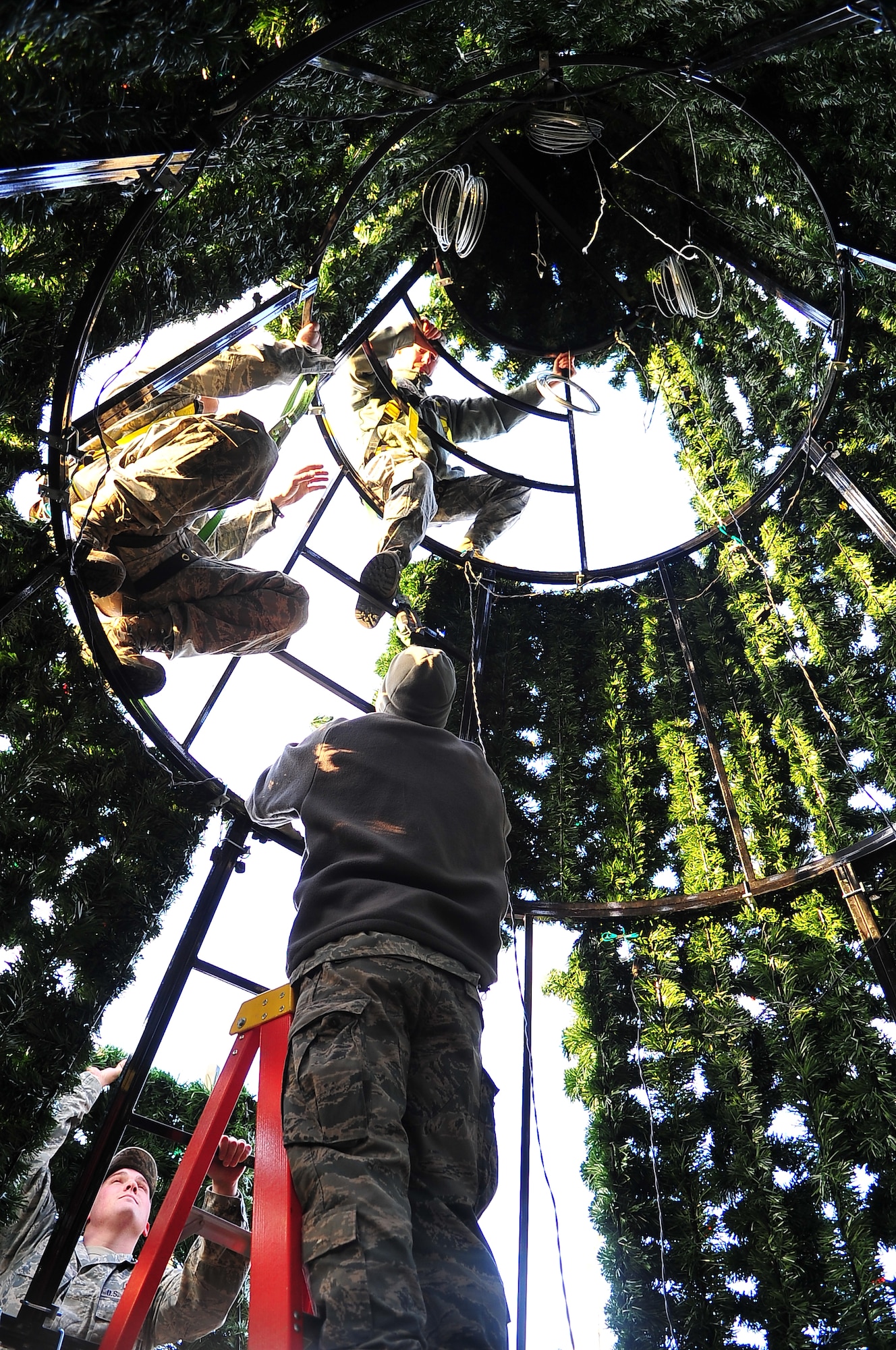 Airmen from the 51st Civil Engineer Squadron secure segments of the base holiday tree to its framework at Osan Air Base, Republic of Korea, Nov. 19, 2012. The tree was prepared for the annual Christmas tree lighting ceremony in front of the base theater. (U.S. Air Force photo/Tech. Sgt. Raymond Mills)
