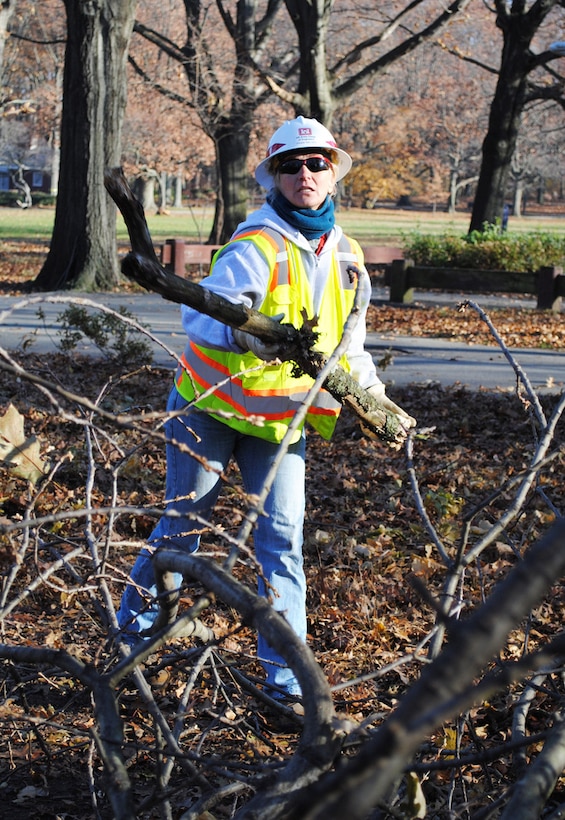 Frani Nelsen, a quality assurance specialist with the U.S. Army Corps of Engineers New York Recovery Field Office, tosses a tree branch, Nov. 22, 2012, into a pile to be chopped and hauled out to temporary collection sites set up throughout New York City. Nelsen is one of more than 150 Corps of Engineers volunteers from around the U.S. helping New York recover.