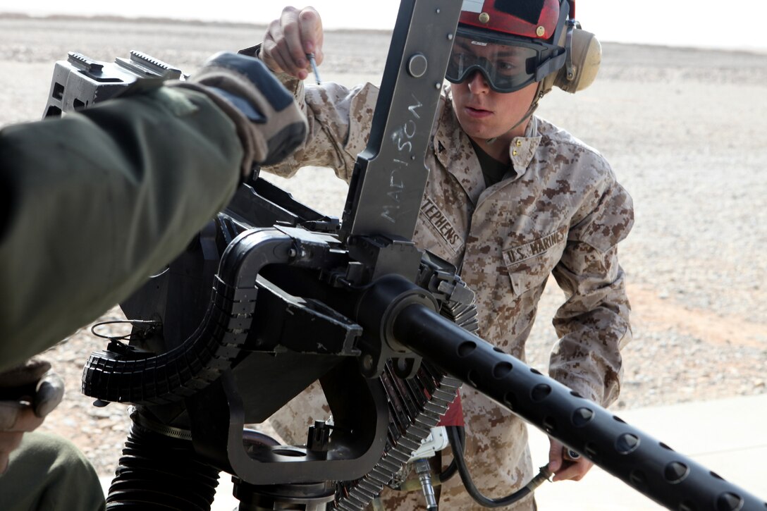U.S. Marine Corps Lance Cpl. Djourdan A. Stephens arms a GAU-21 .50 caliber machine gun at Camp Dwyer, Helmand province, Afghanistan, Nov. 27, 2012. 